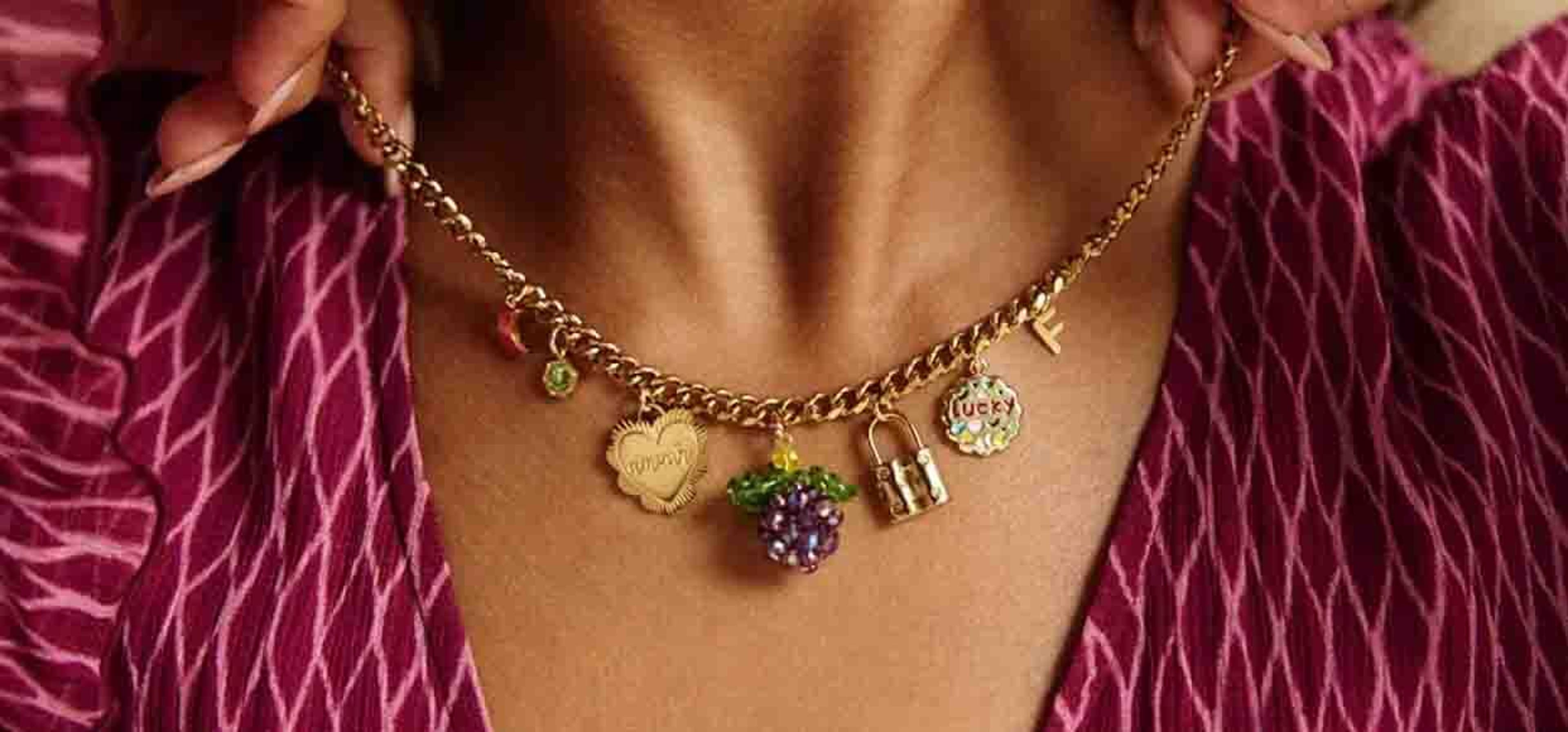 close up shot of a woman wearing a chunk necklace with gems