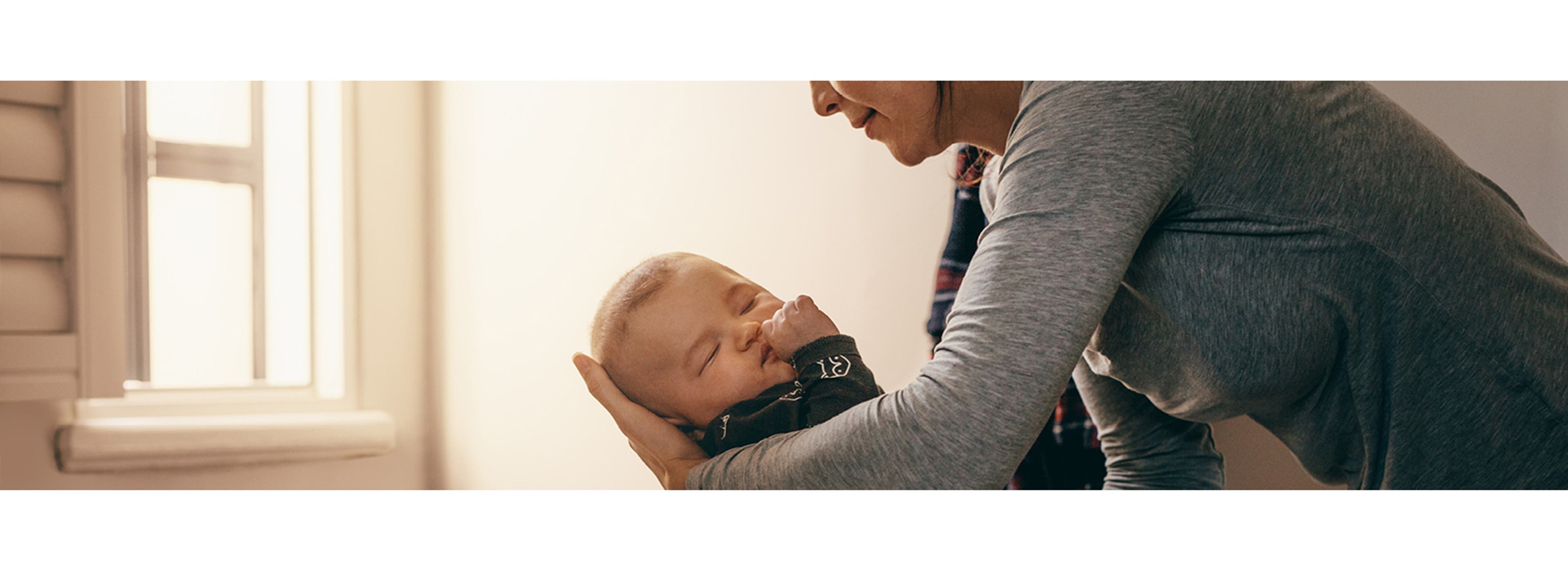 mother putting baby to bed