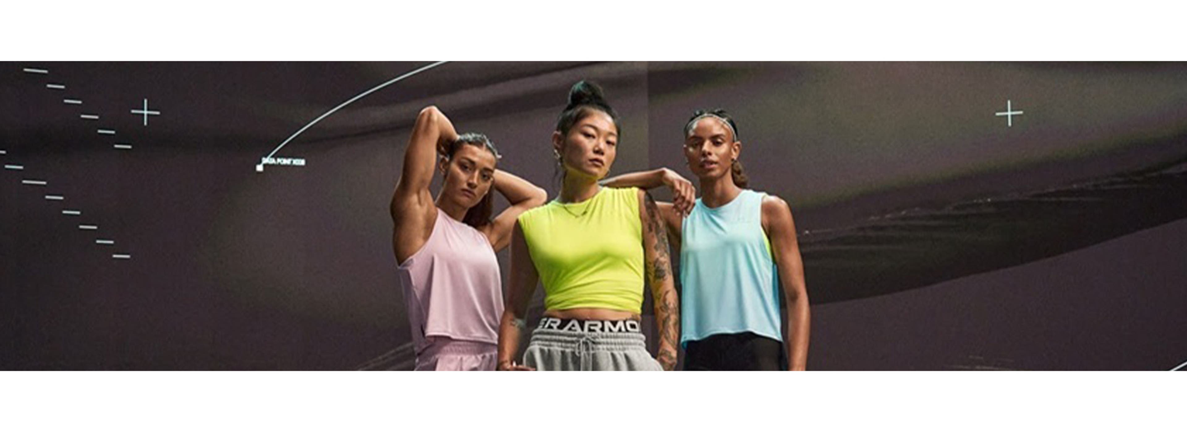 Three women in athleisure wear posing for a picture