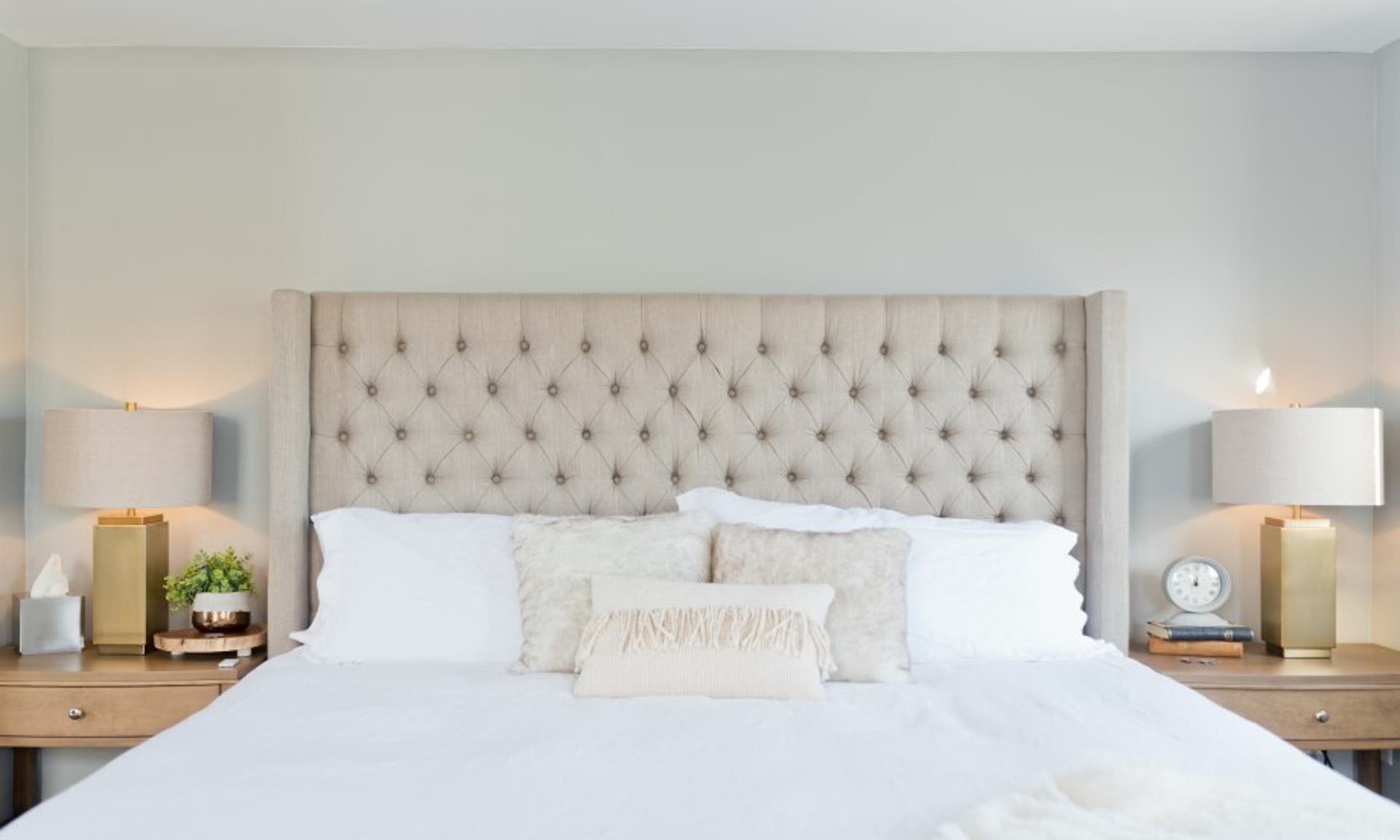  image of a tidy, comfortable bed with white bedding. 