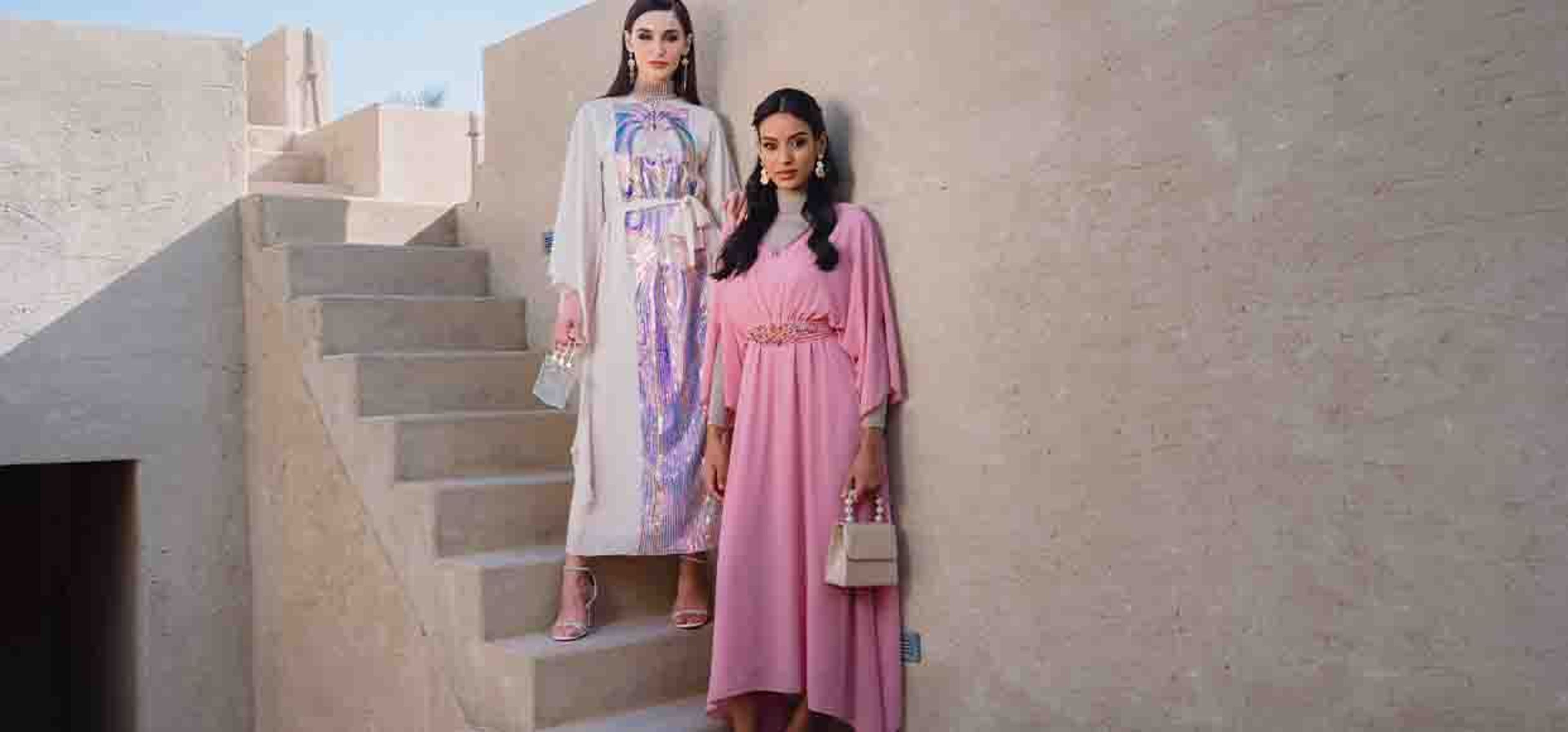 two girls posing with maxi dresses on
