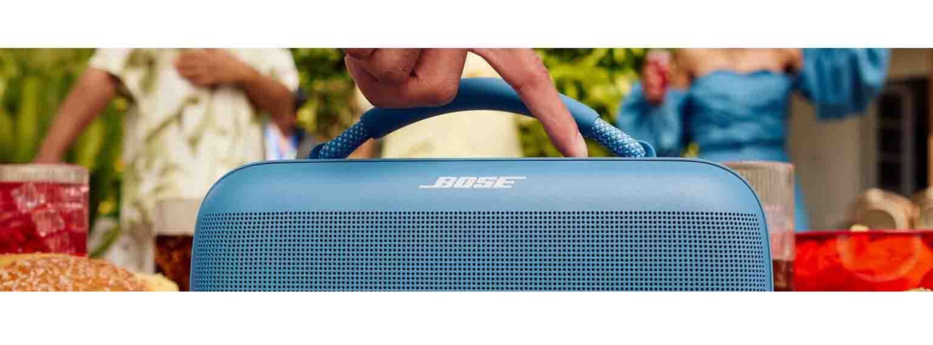Garden party with blue bose speaker in centre of image