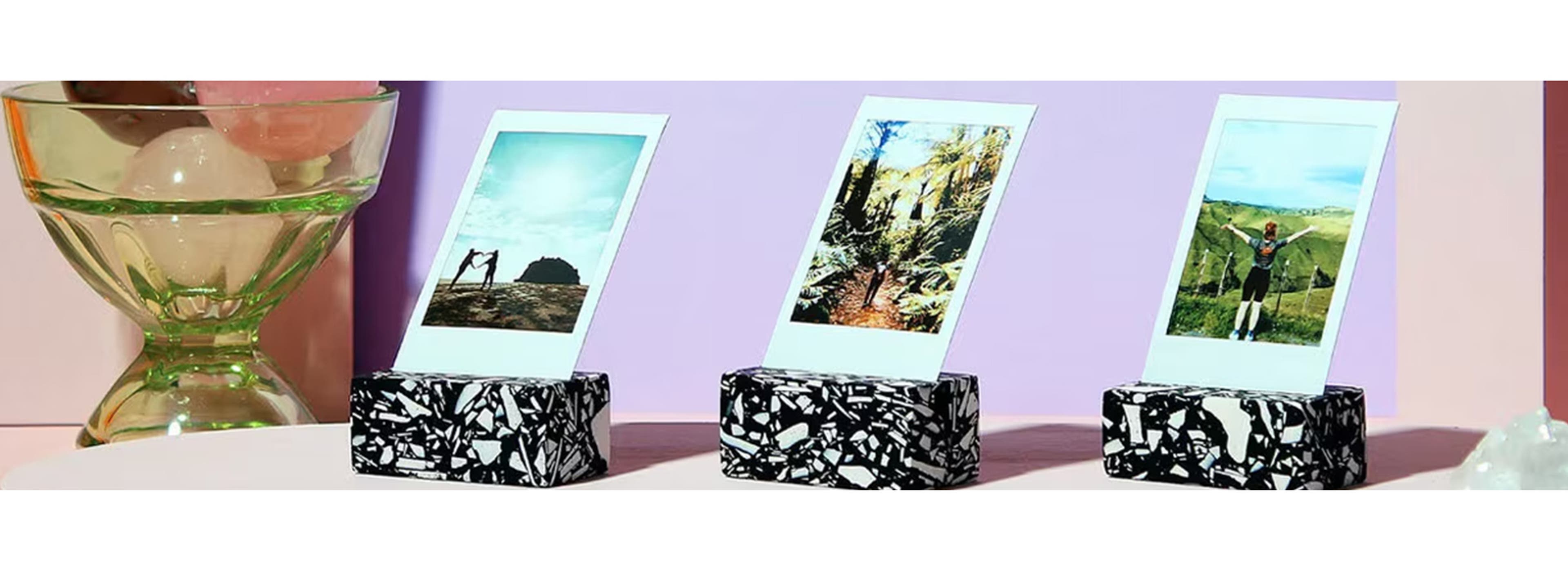 Pink background with 3 polaroid picture stands