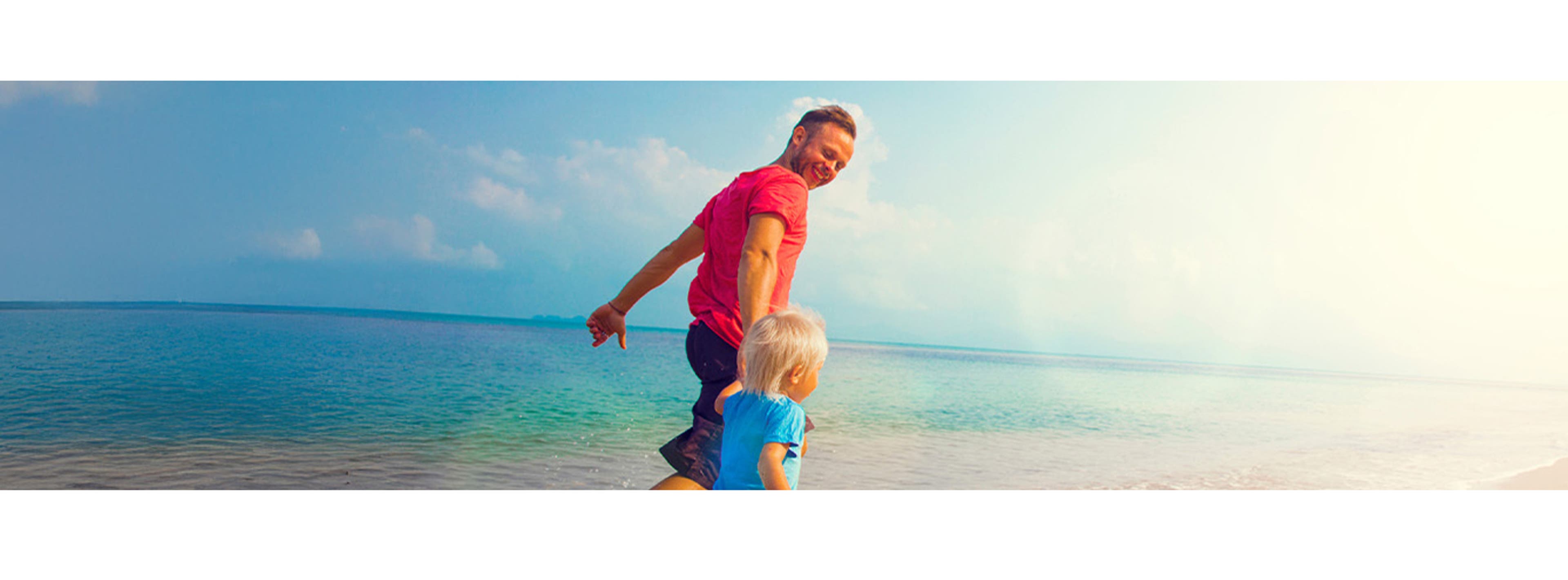 son and dad running on the beach