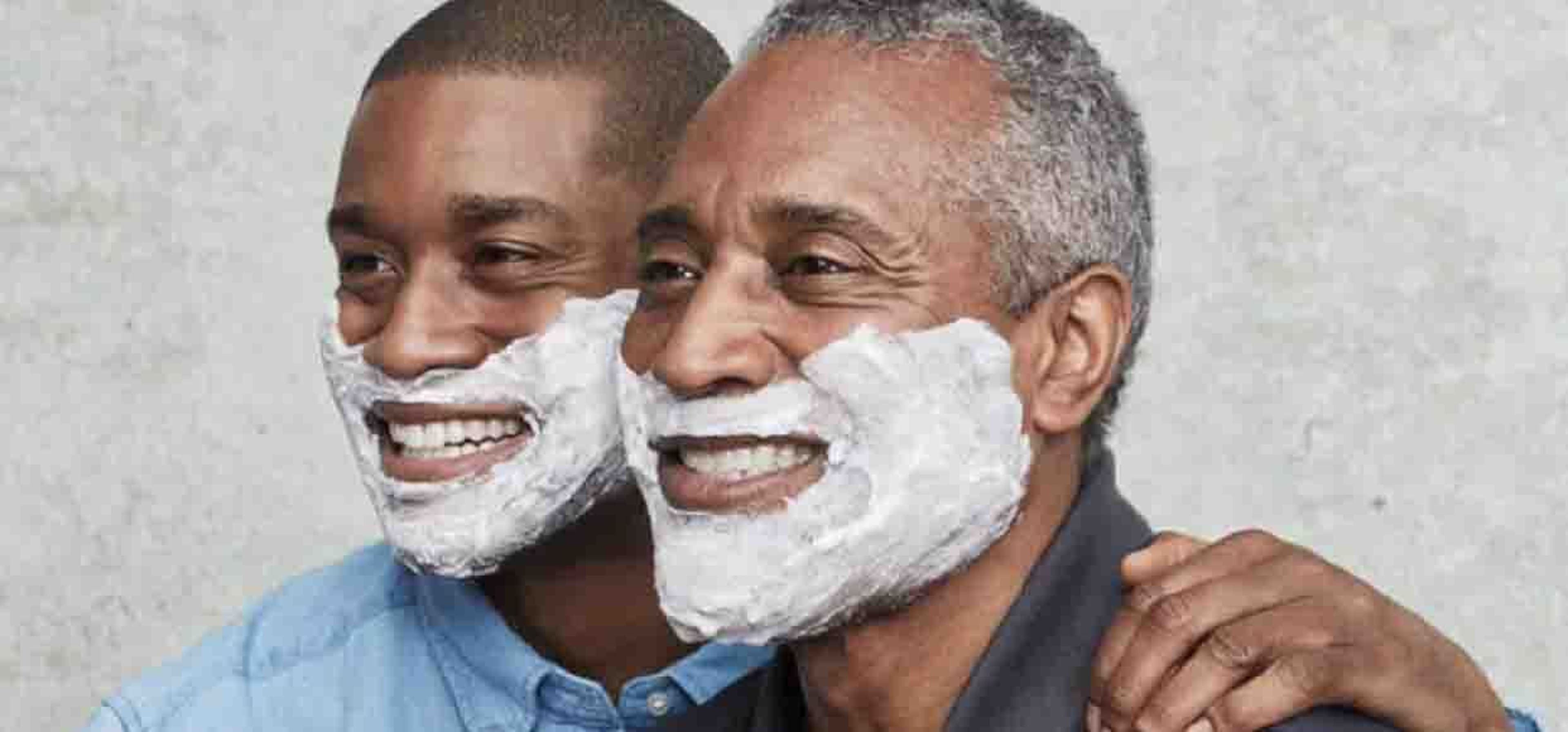 two black men smiling with shaving cream on their faces