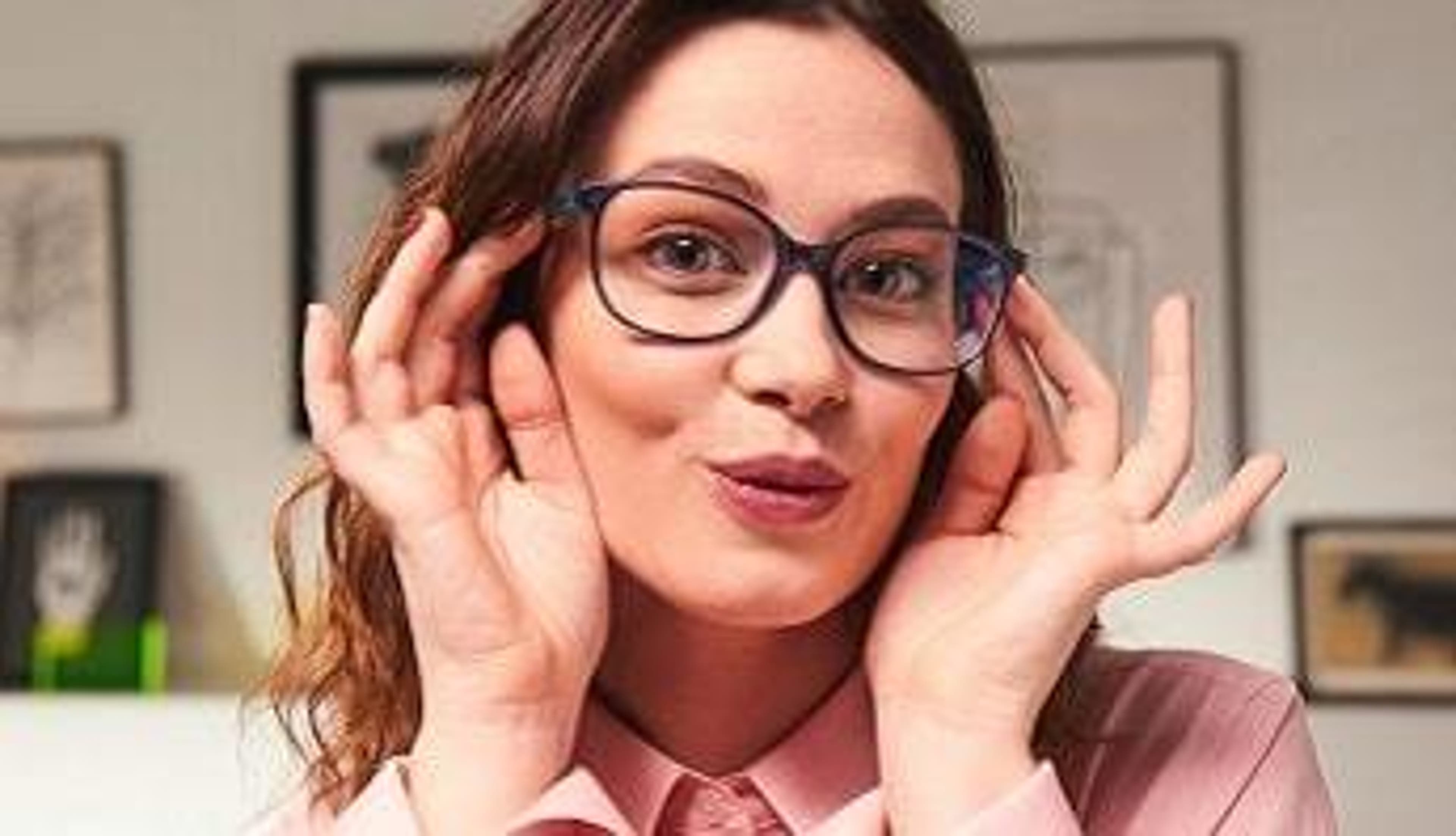  An excited woman wears new glasses from Glasses Direct 
