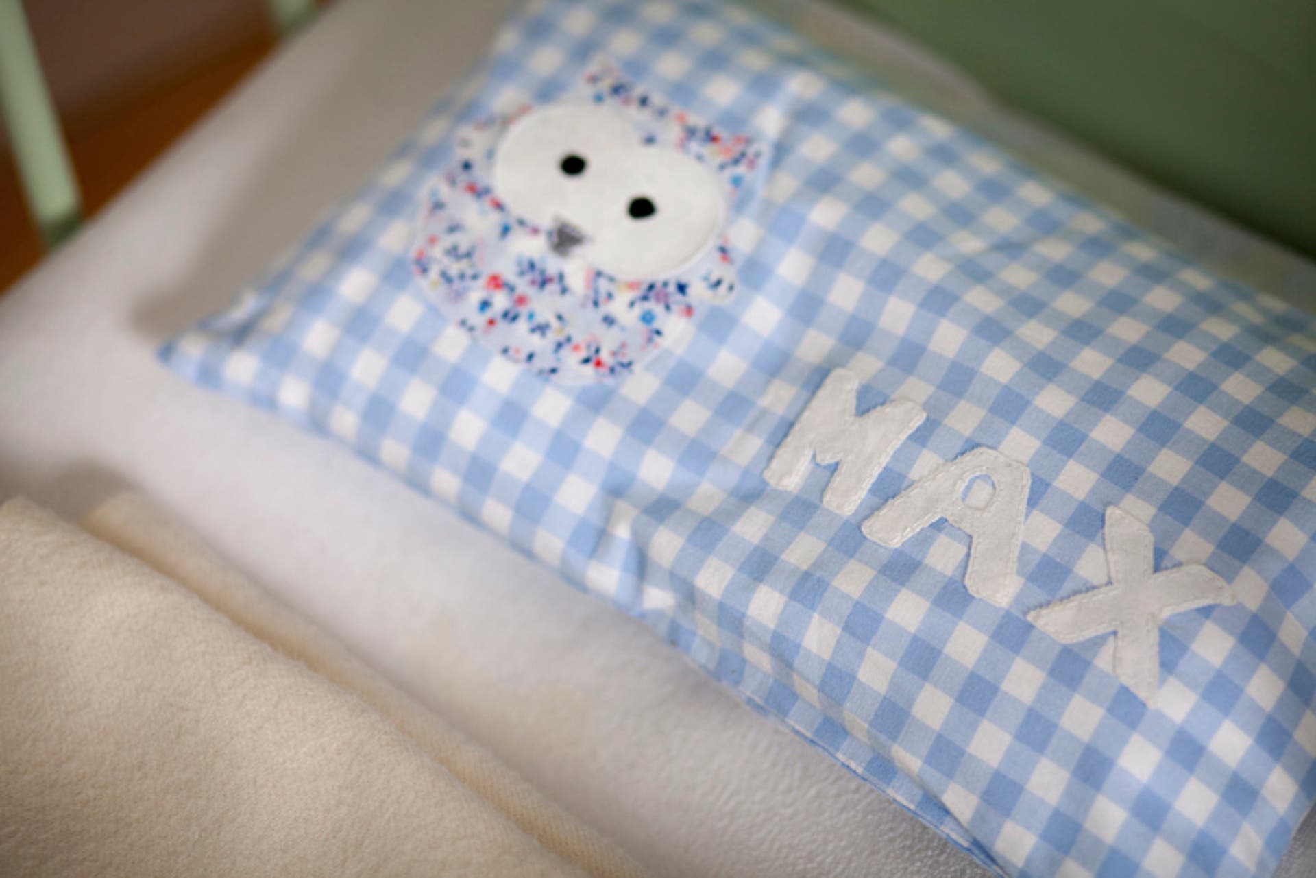  a personalised pillow In a baby crib 