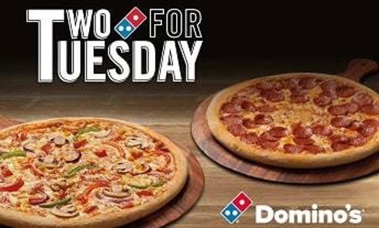  A vegetarian and a pepperoni pizza sat on wooden trays next to the Domino's logo and text that reads "Two for Tuesday" 