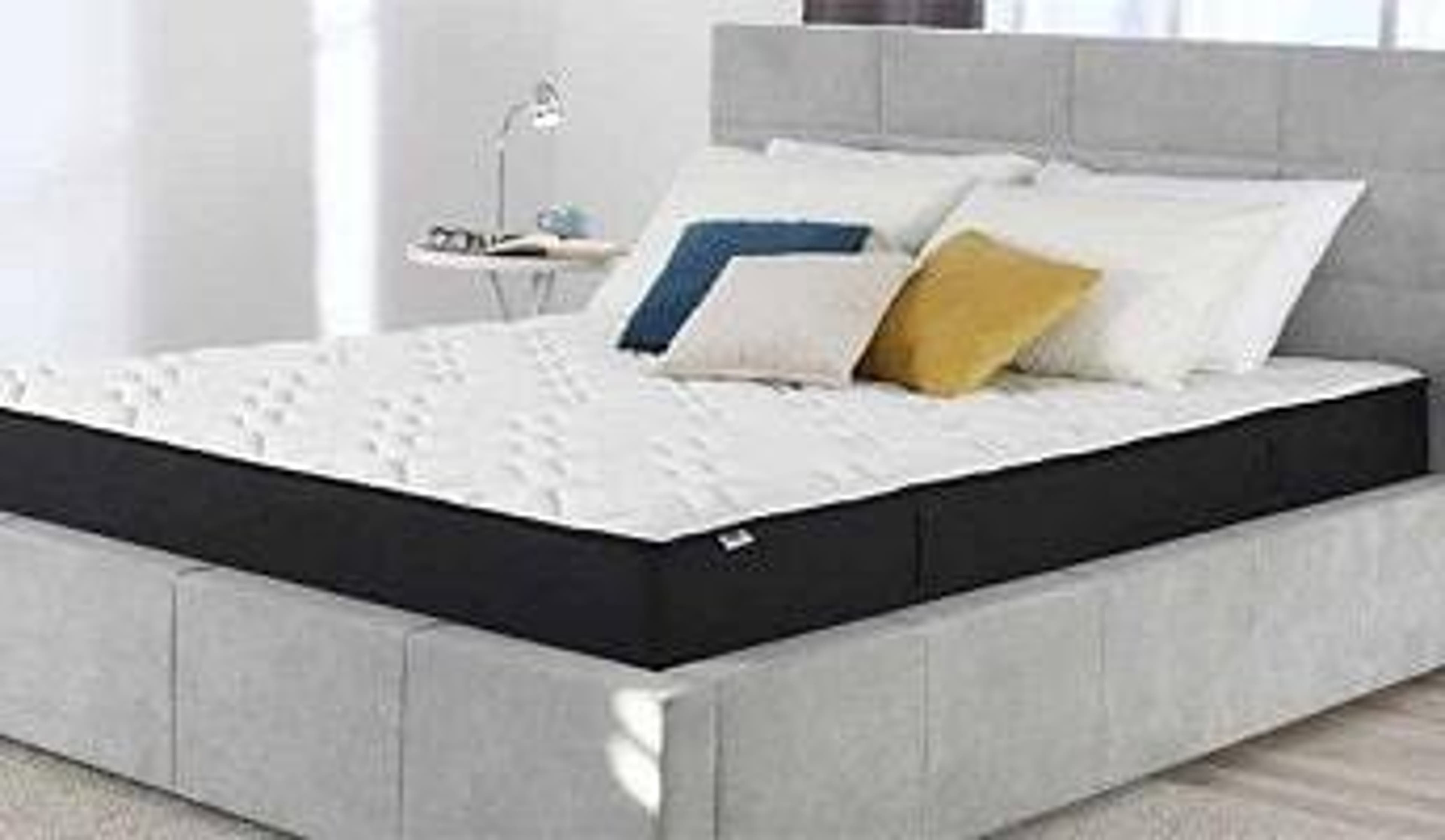  A Dormeo mattress on a grey bedframe 