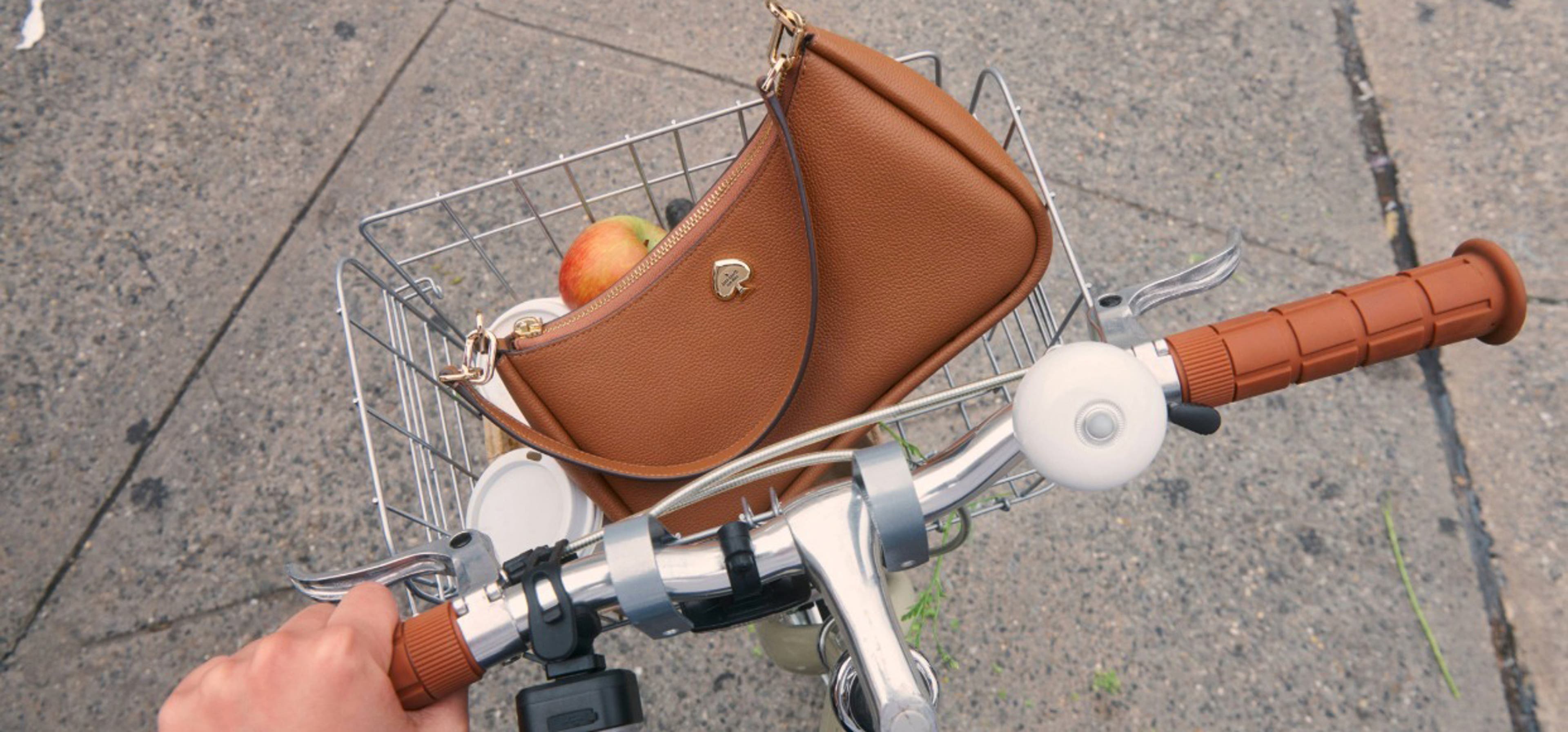 Bicycle basket with brown kate spade bag in