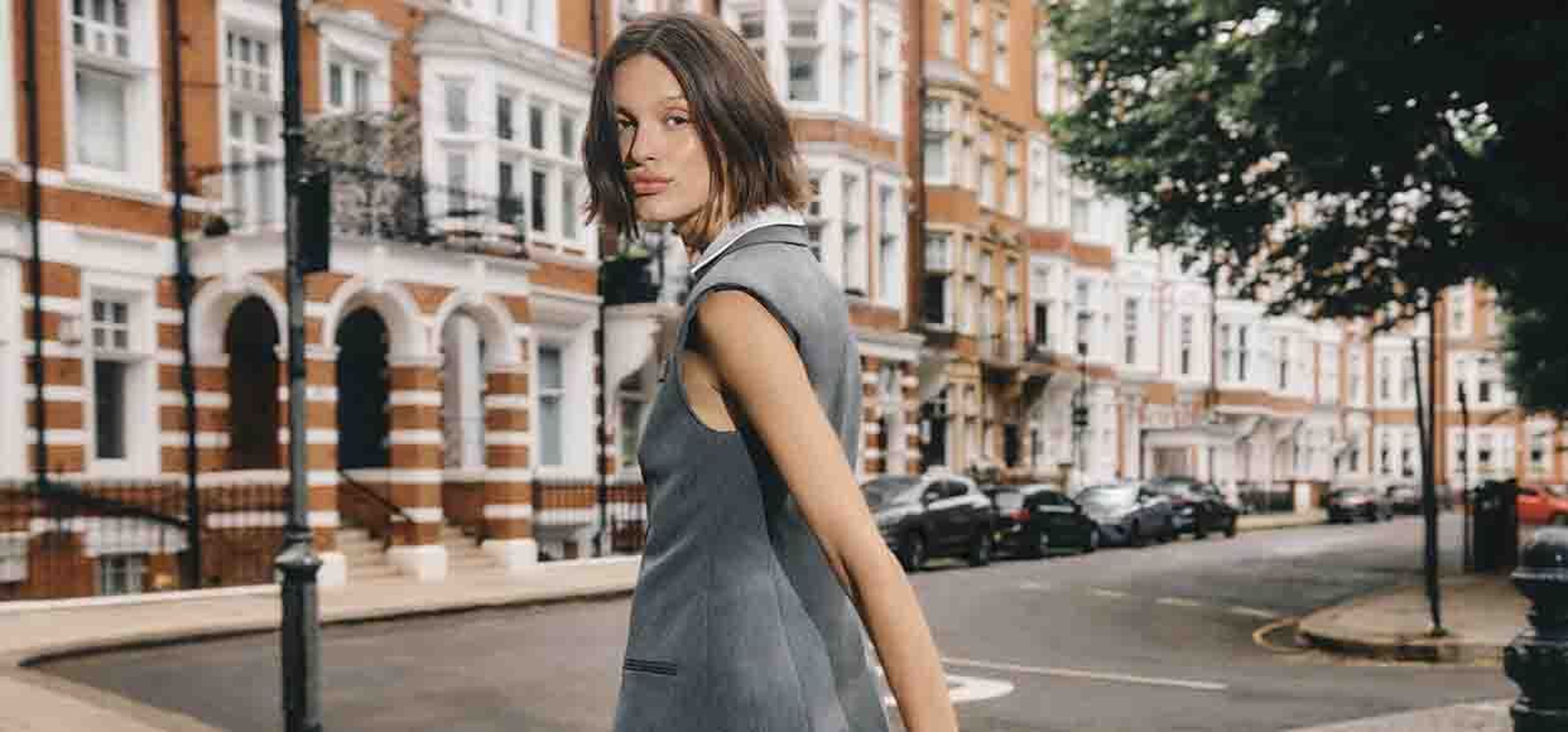 woman in grey outfit posing in london streets