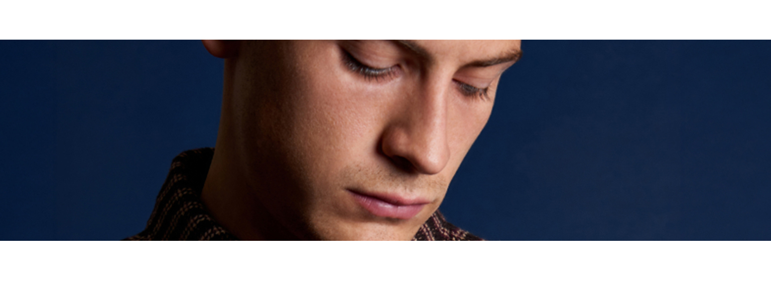  man looking down at his pocket 