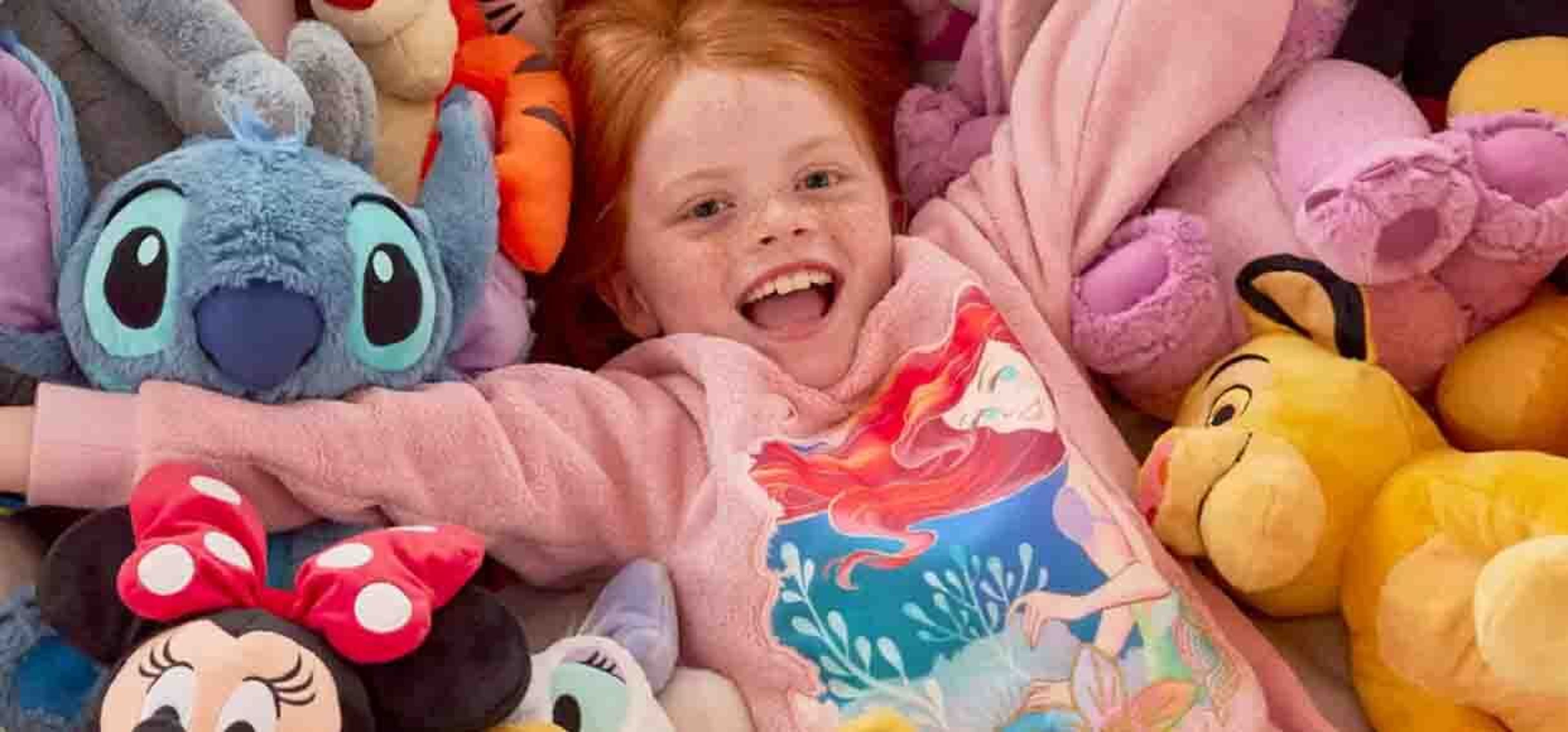 A little girl playing in amongst a sea of teddies