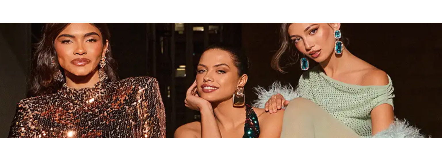  Three woman posing n sparkly dresses 