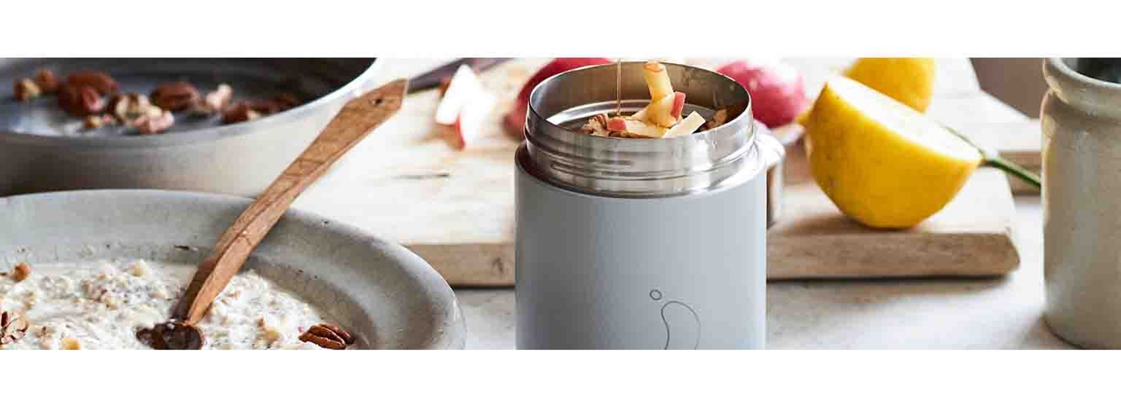 person pouring honey in a foot pot filled with apples
