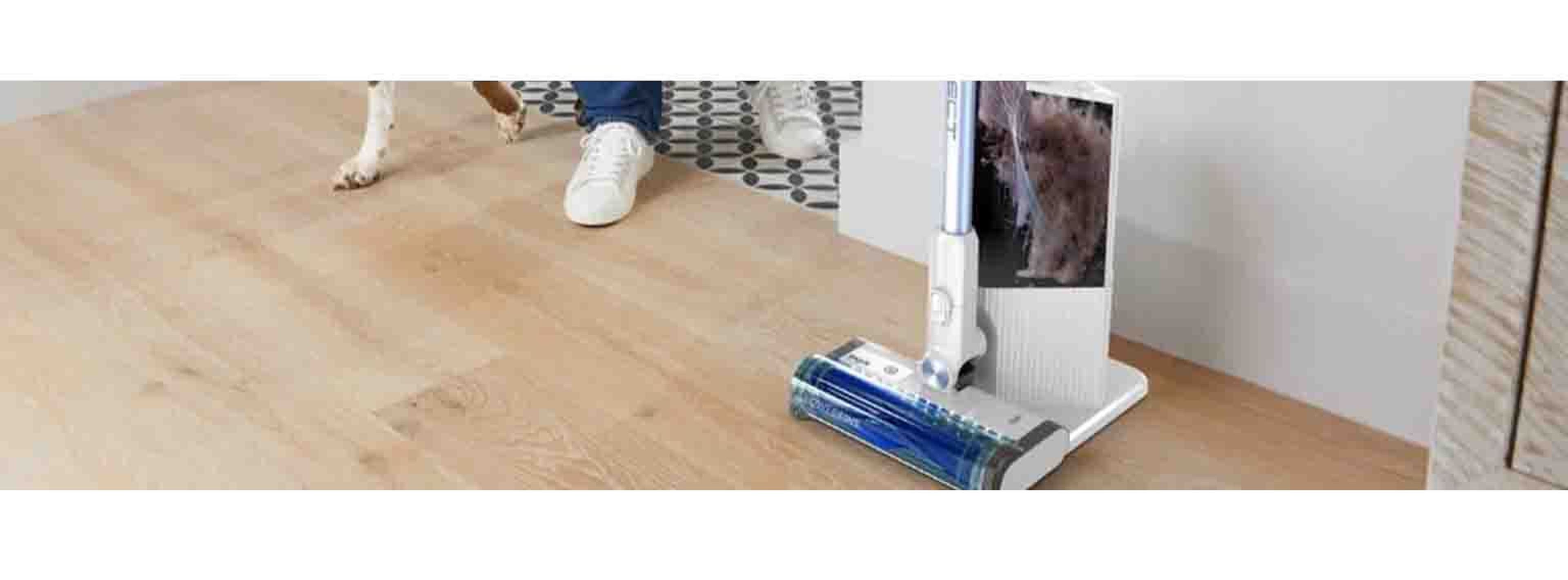 man with dog next to pet vaccum