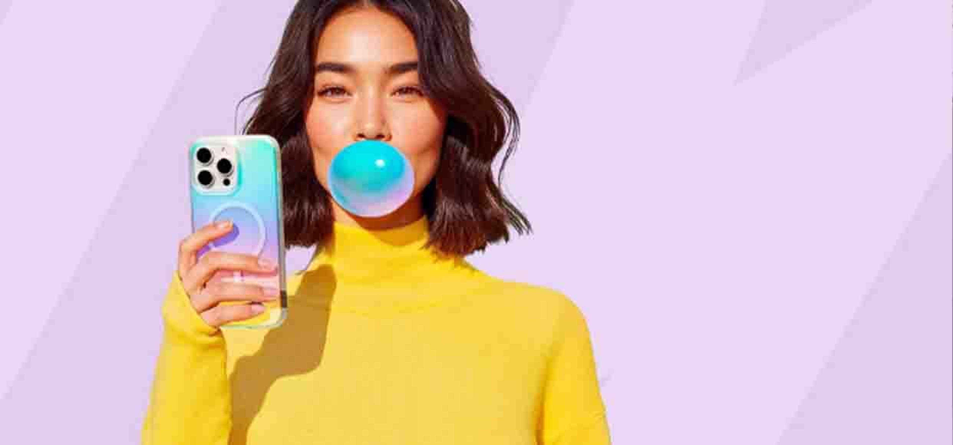 woman blowing gum while holding phone