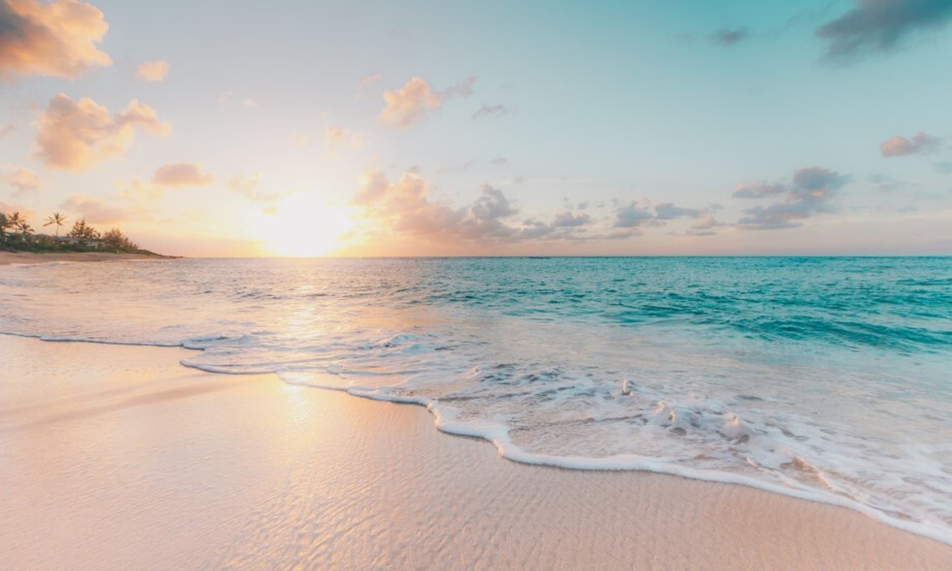  a peaceful, calming image of a shoreline in Hawaii with white sand and light blue water. 