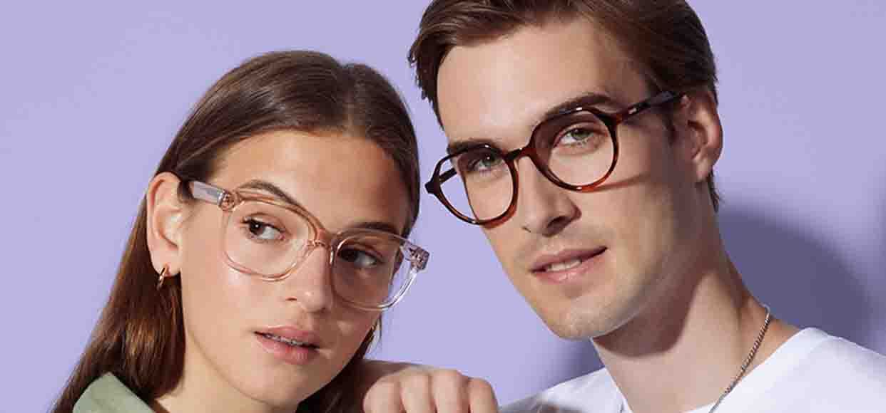  two people posing in glasses back to back  