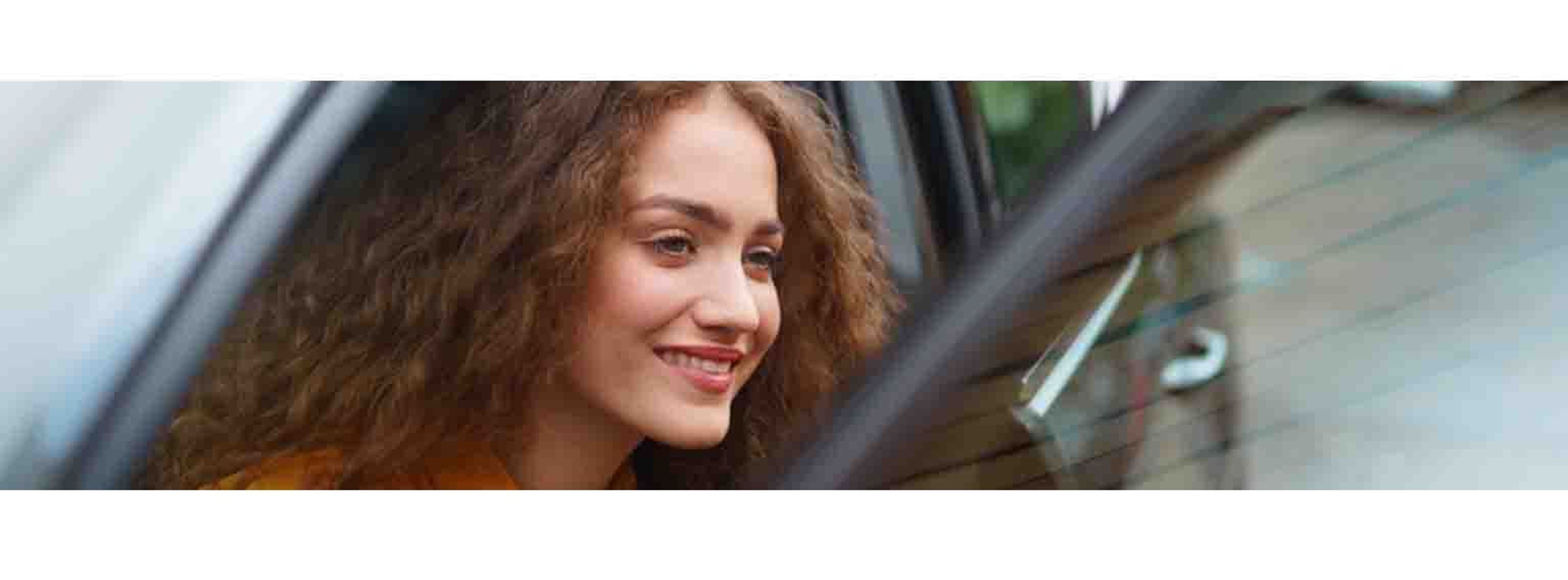 woman getting out of car