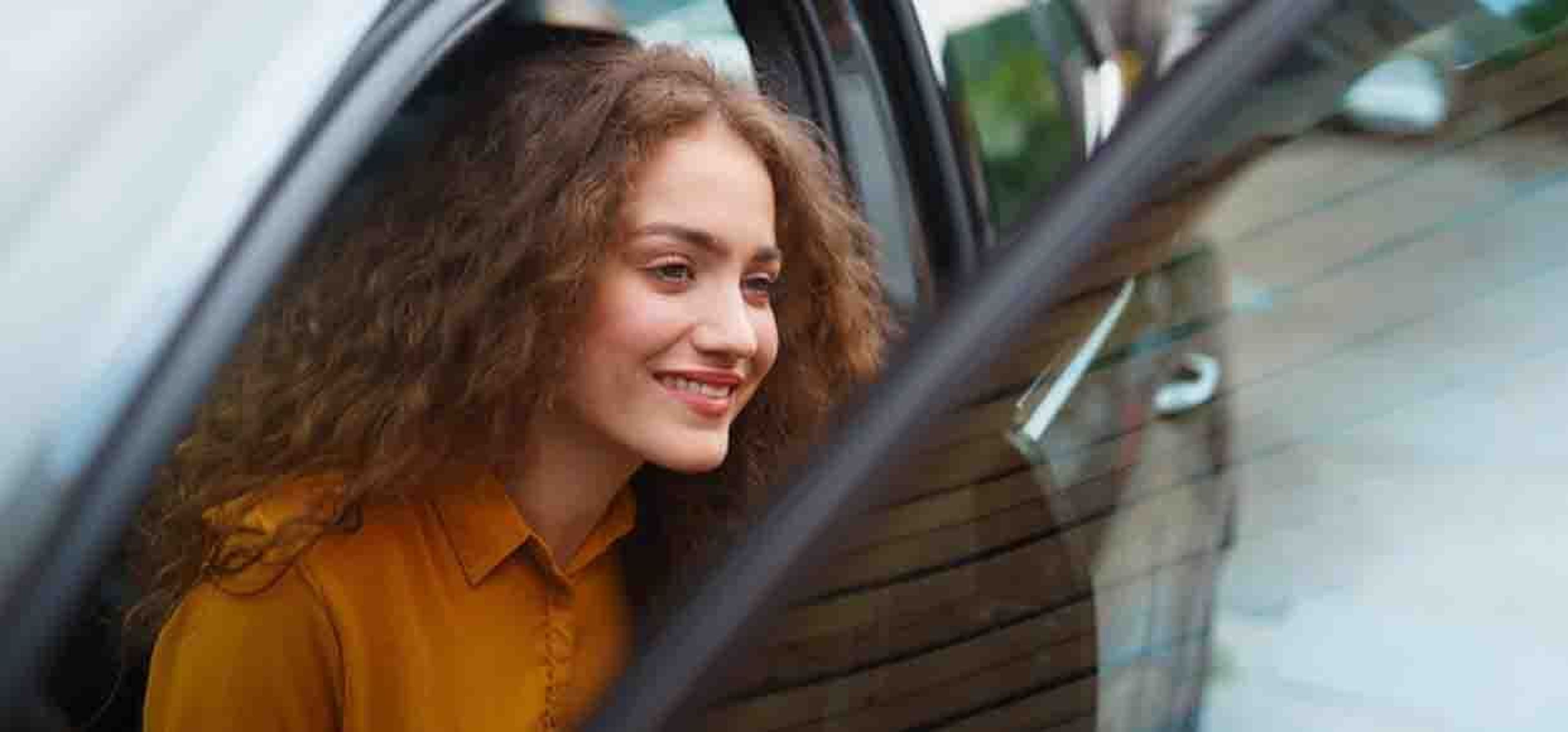 woman getting out of car