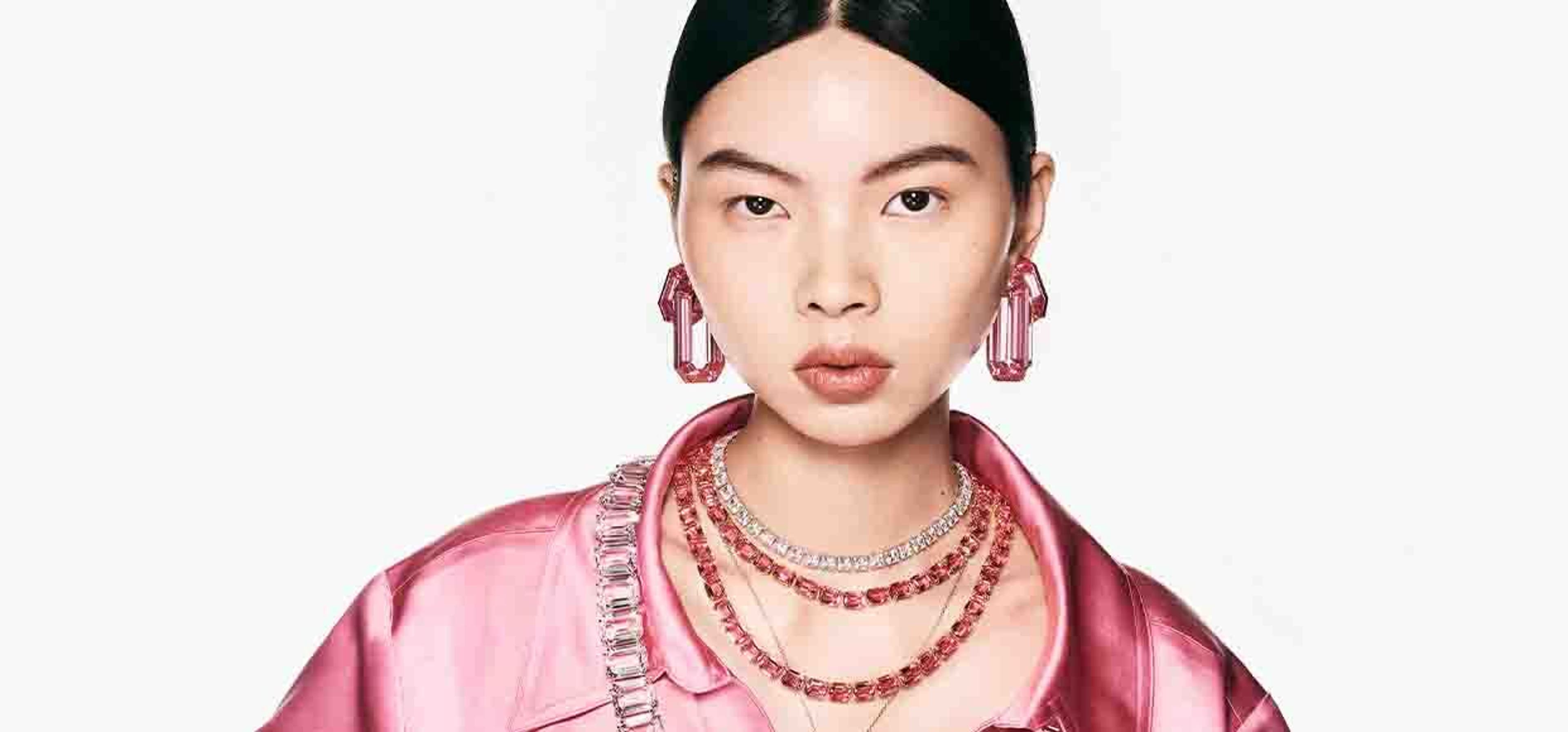 picture of an asian woman wearing pink top with swarovski jewellery