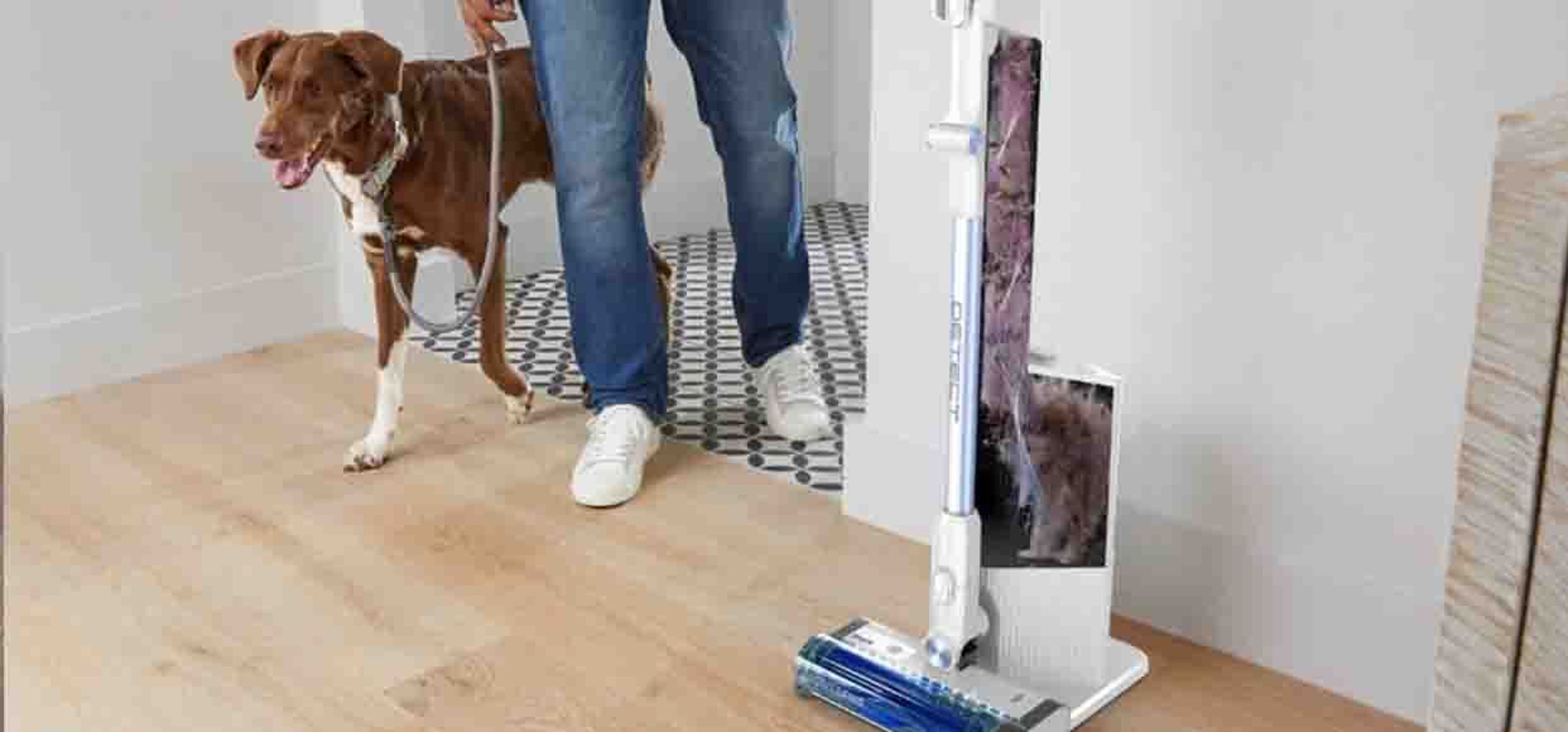 man with dog next to pet vaccum