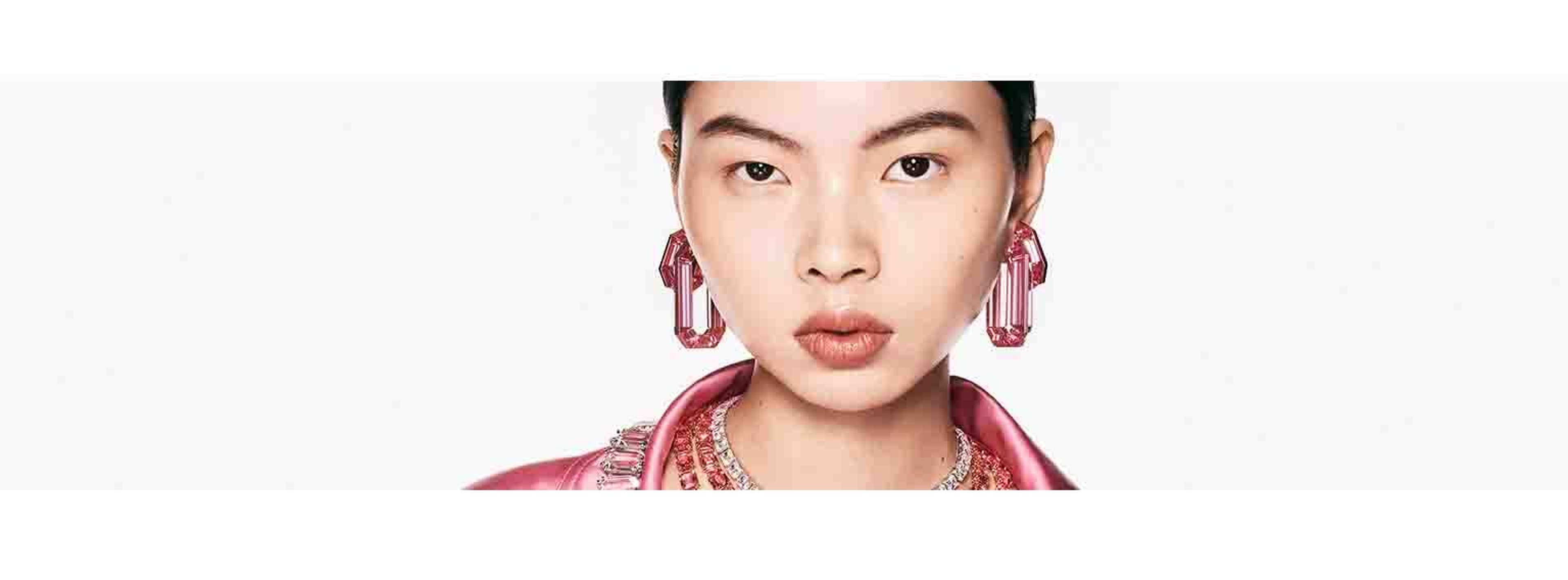 picture of an asian woman wearing pink top with swarovski jewellery