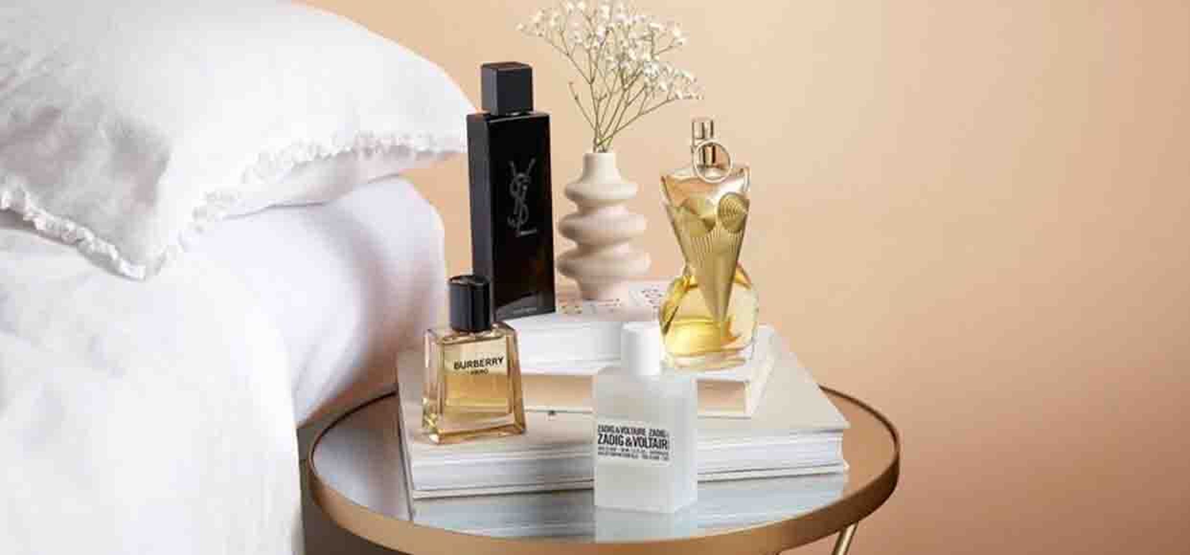 image of perfumes on a bed side table