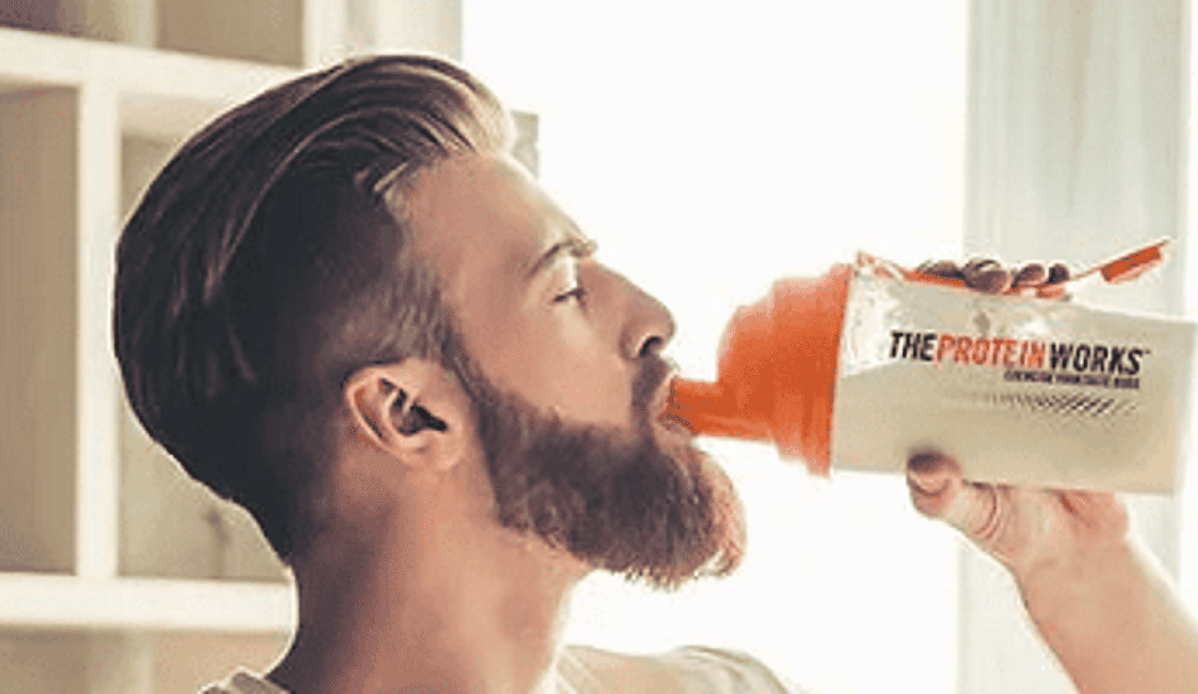  A man drinking a The Protein Works Supplements 