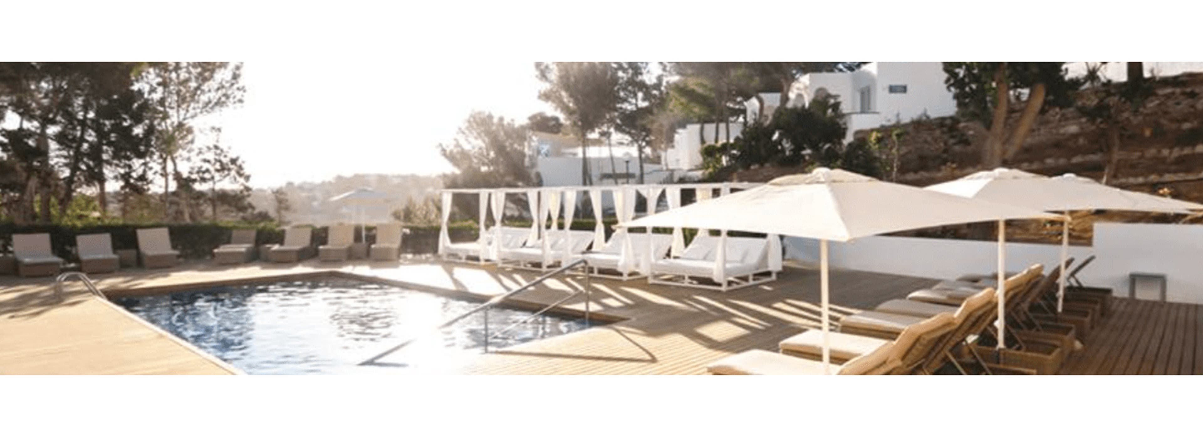 A picture of a villa with the pool view and the pool chairs