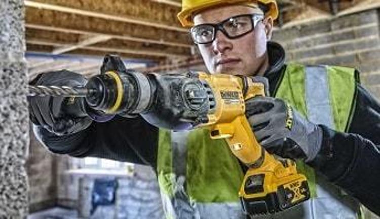 A construction worker using a DeWALT drill from ToolStation