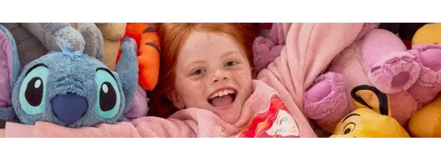  A little girl playing in amongst a sea of teddies 
