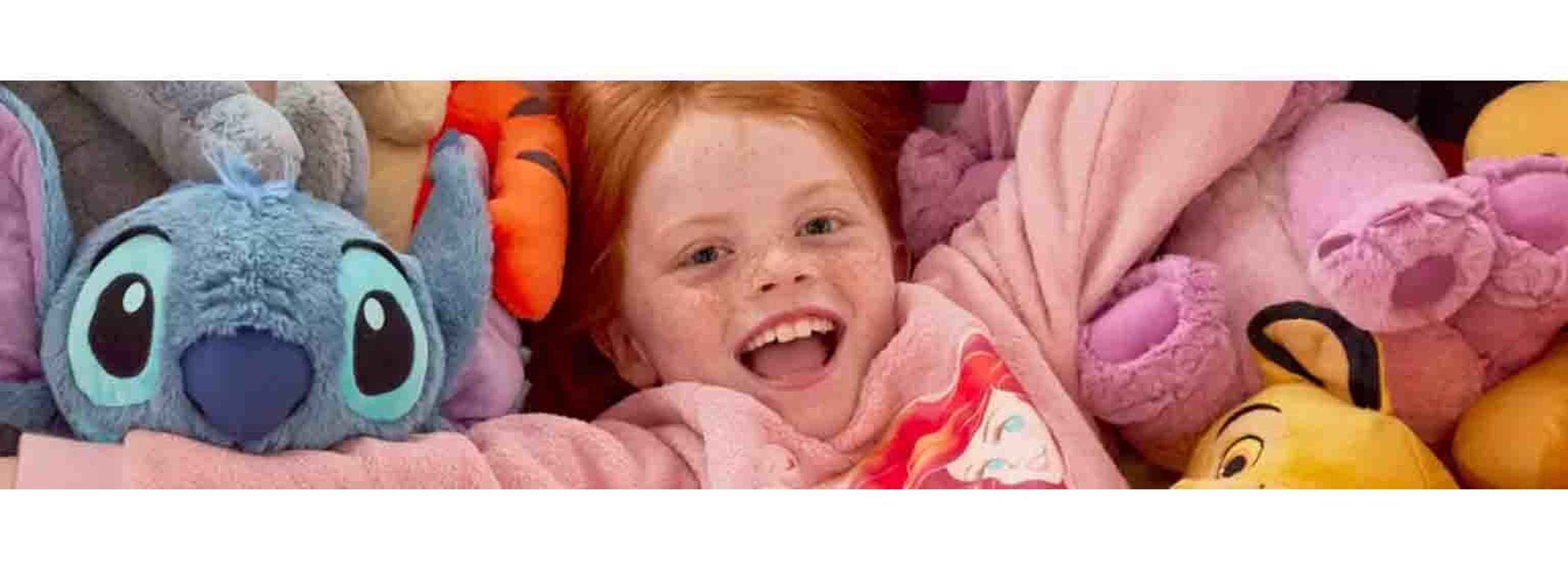A little girl playing in amongst a sea of teddies