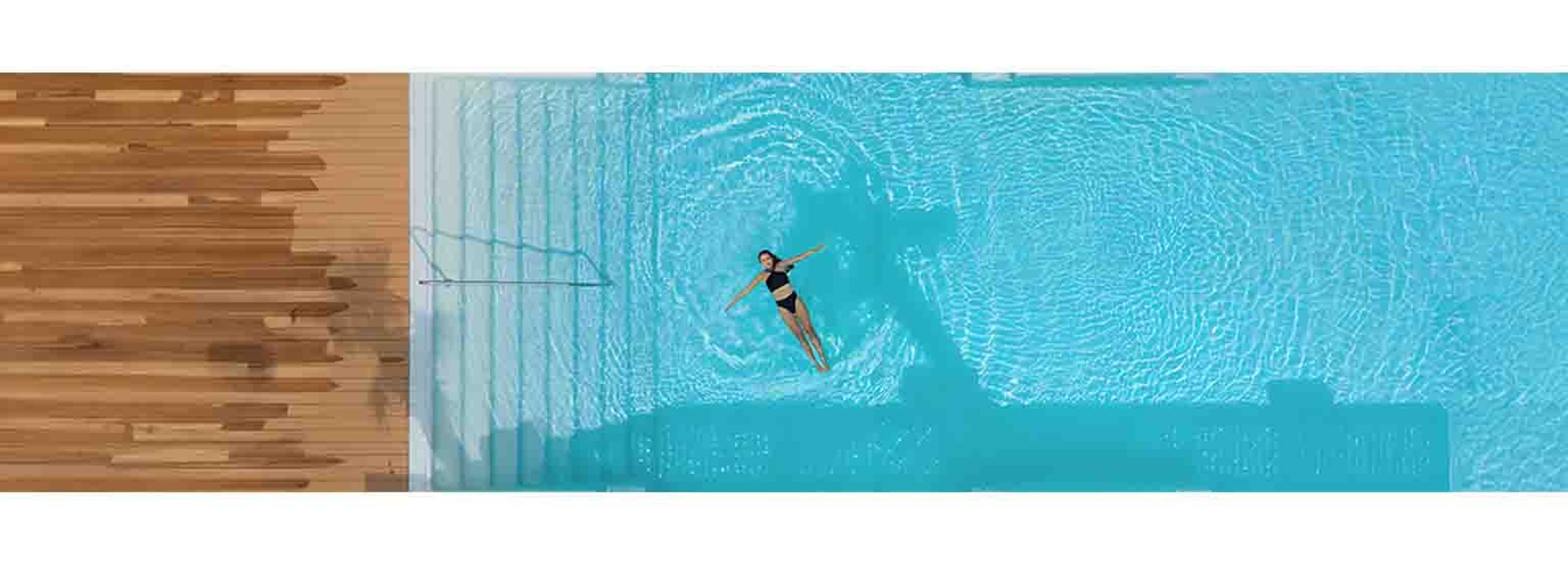 woman floating in pool birds eye view