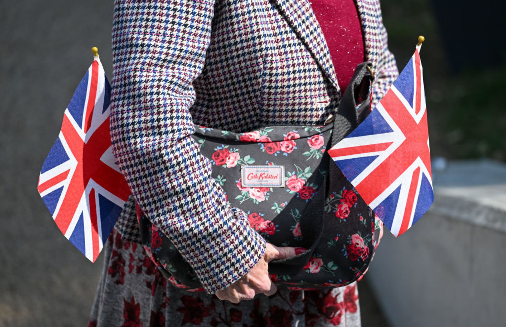  A woman holds a Cath Kidston handbag and Union Jack flags 