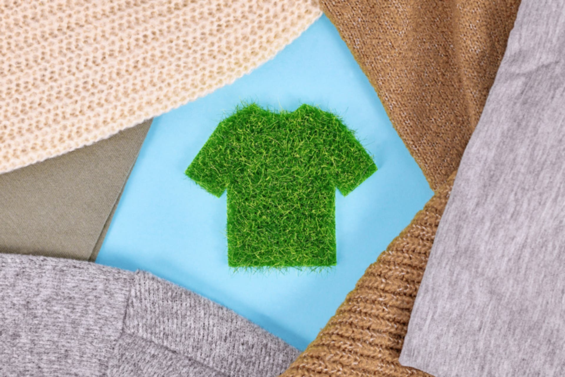  A shirt made out of grass surrounded by sweaters 