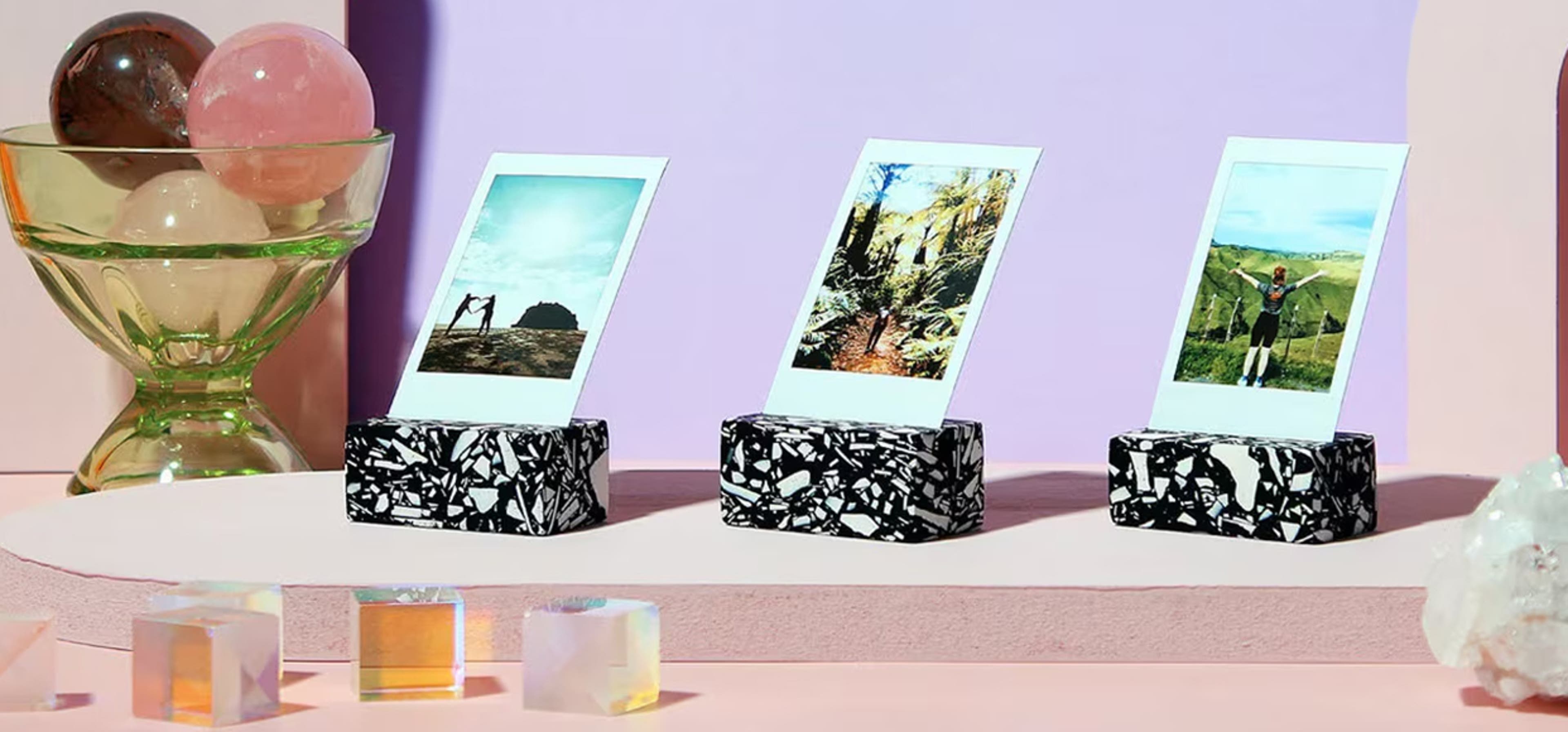 Pink background with 3 polaroid picture stands