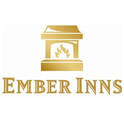 the ember inns logo written in gold on a white background. The image features a golden lit hearth in the centre with the name ember inns below it