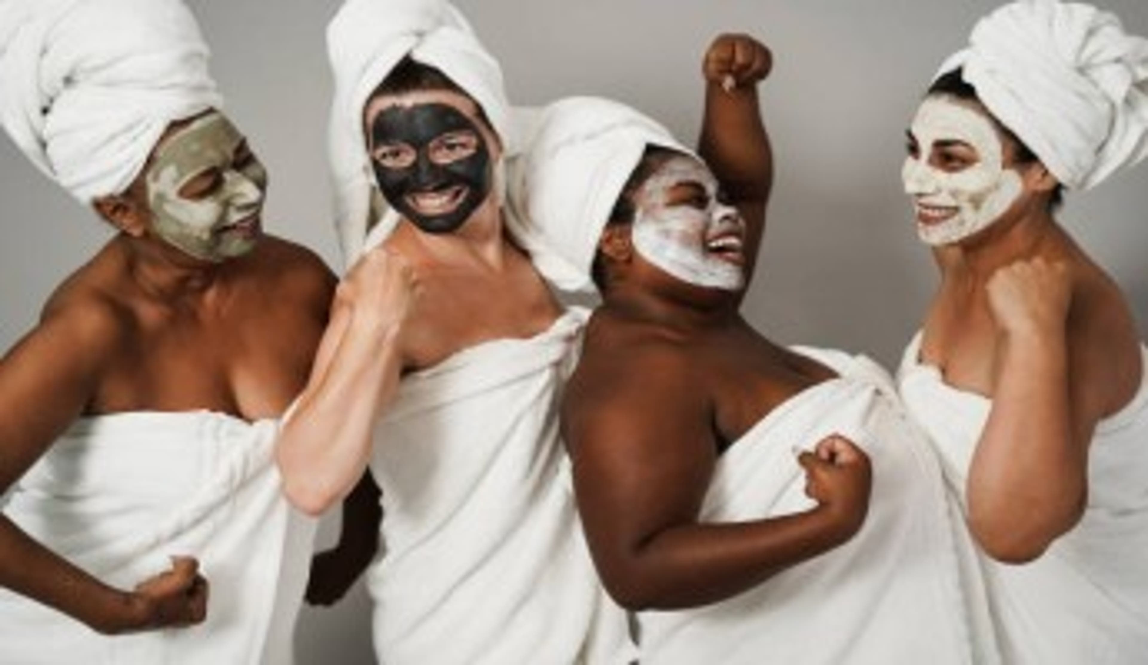  Four women in towels with mud facials 