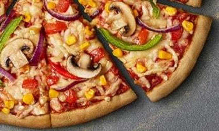  A slice of Domino's Vegan Vegi Supreme pizza 