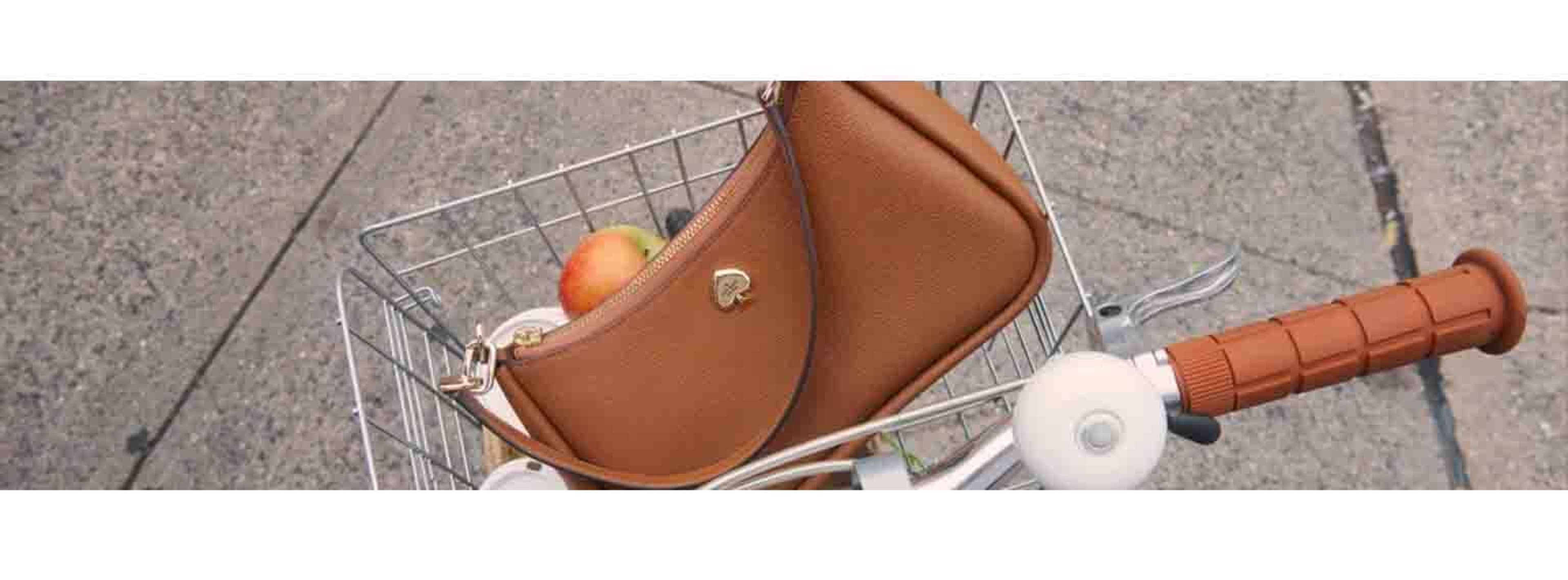 Bicycle basket with brown kate spade bag in