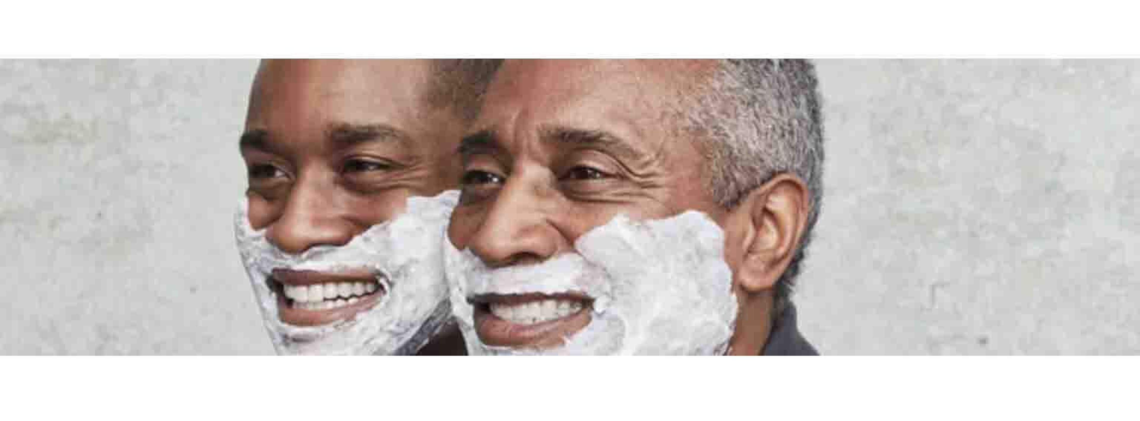 two black men smiling with shaving cream on their faces