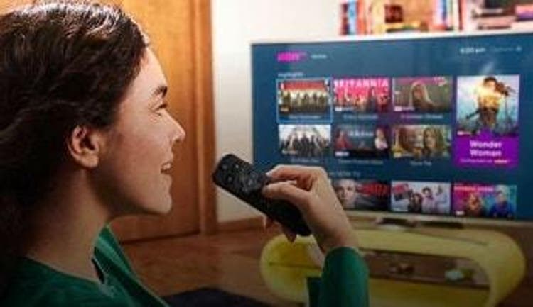  A woman browses the selection of NOW TV shows & movies on her Smart TV 