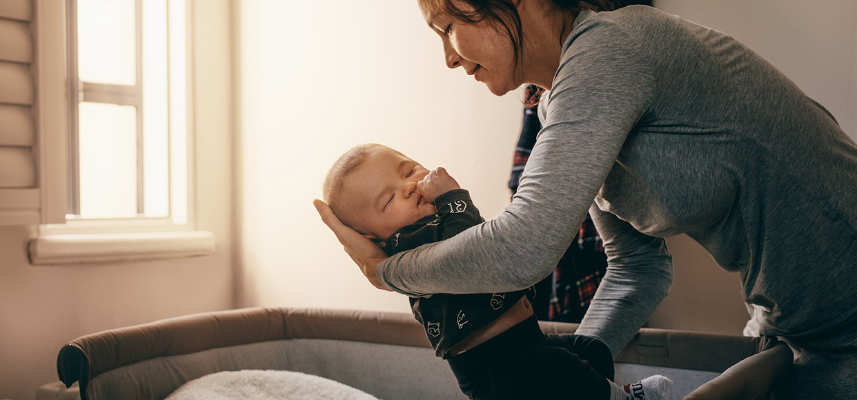  mother putting baby to bed 