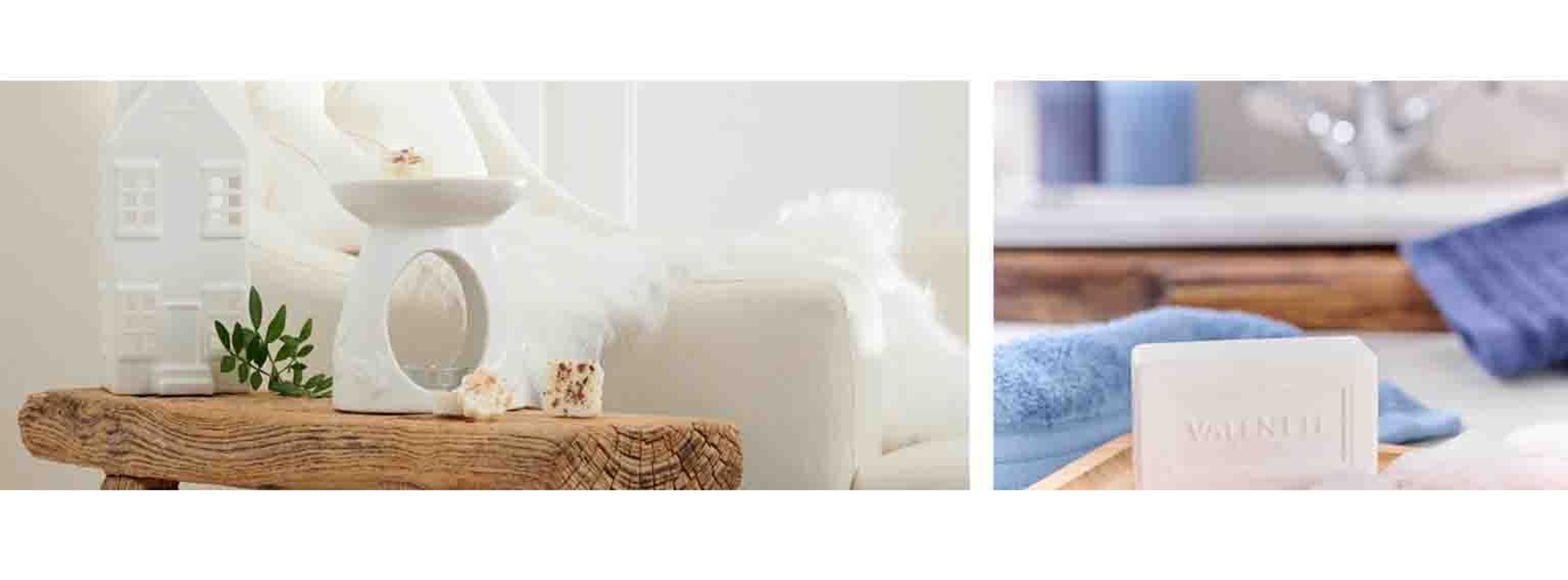 Candle on a side table next to a white chair