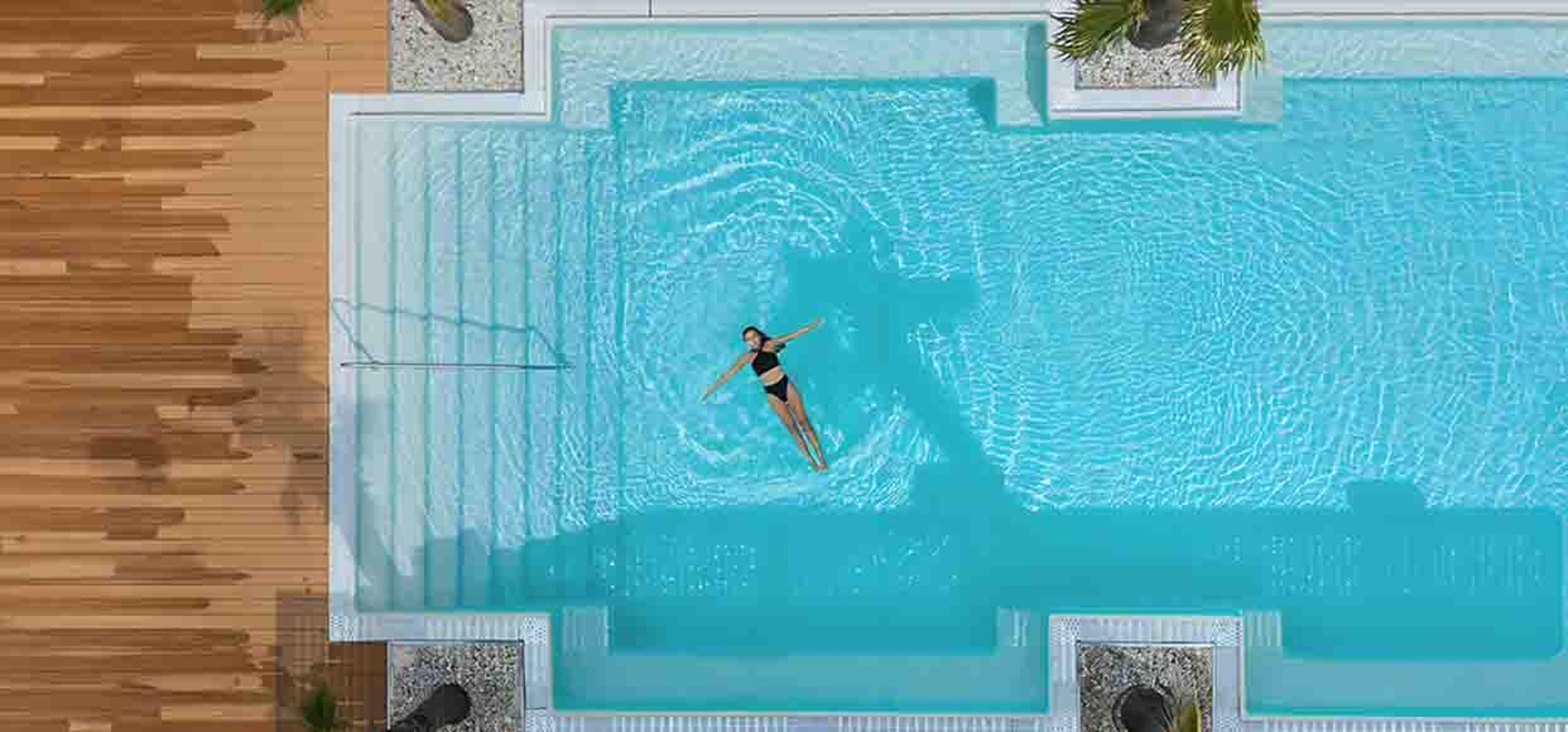 woman floating in pool birds eye view