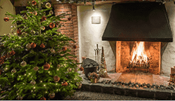 A Vintage Inns pub with fireplace and Christmas tree