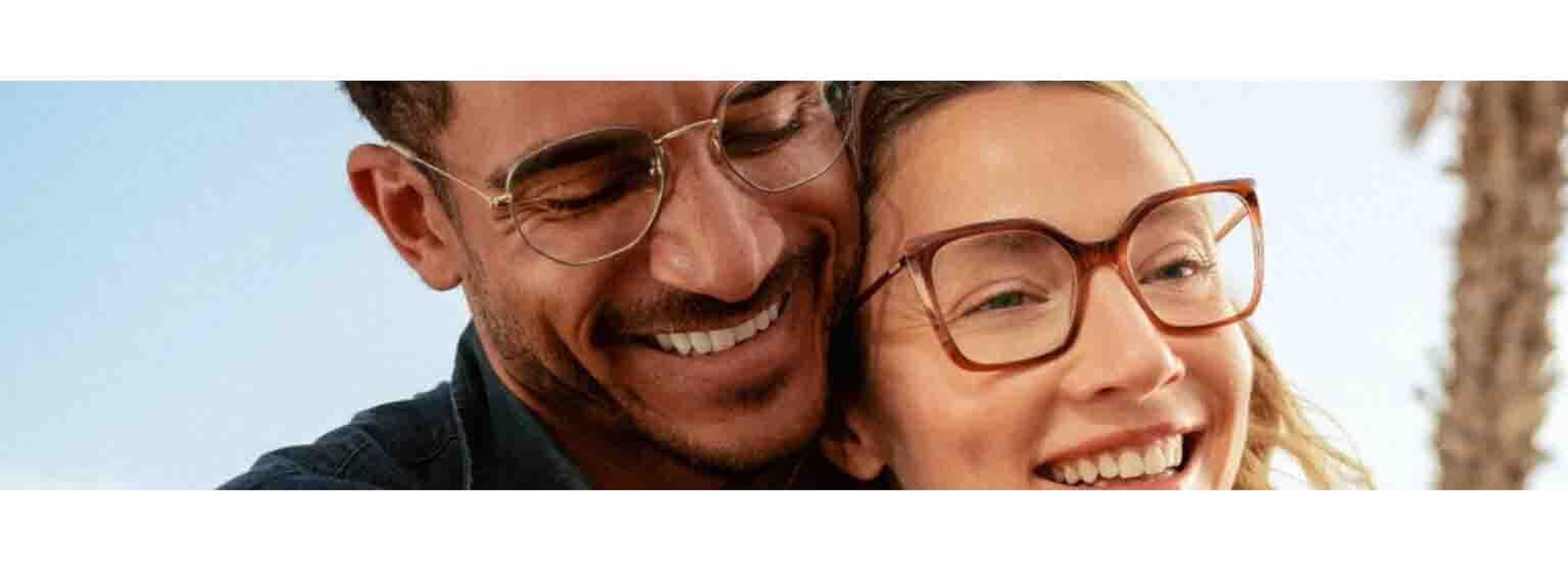 two couples smiling happily wearing glasses