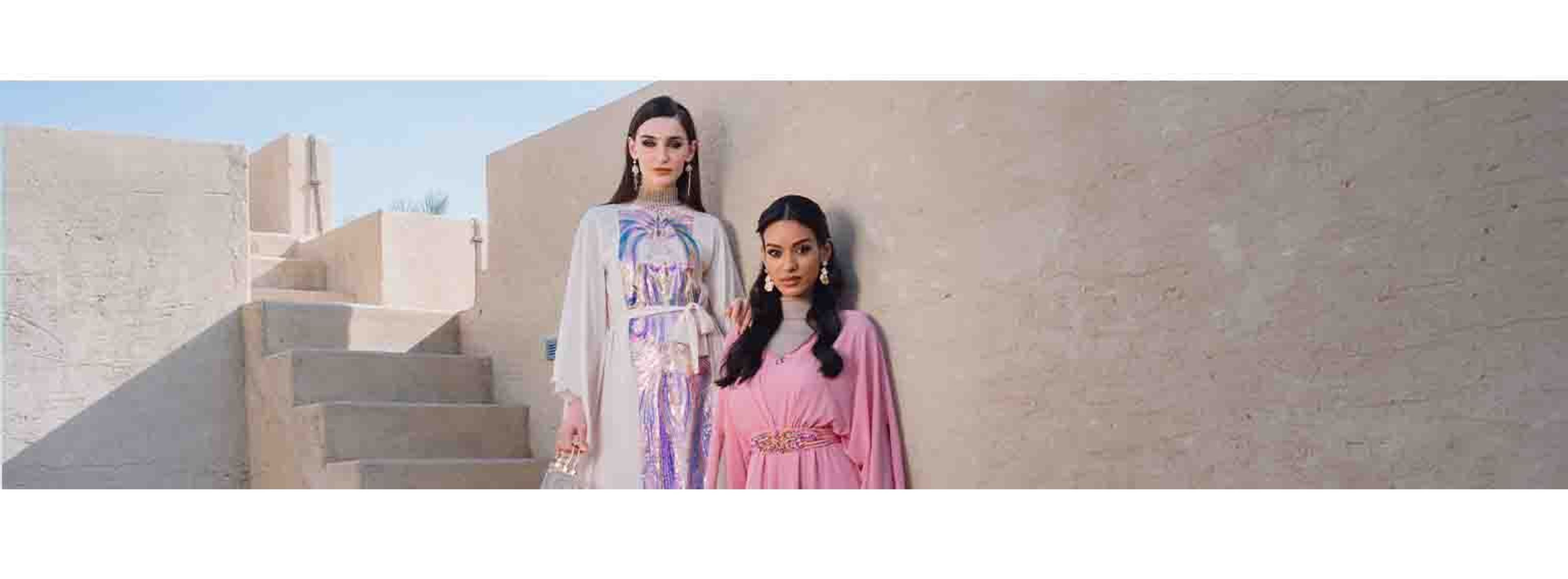 two girls posing with maxi dresses on